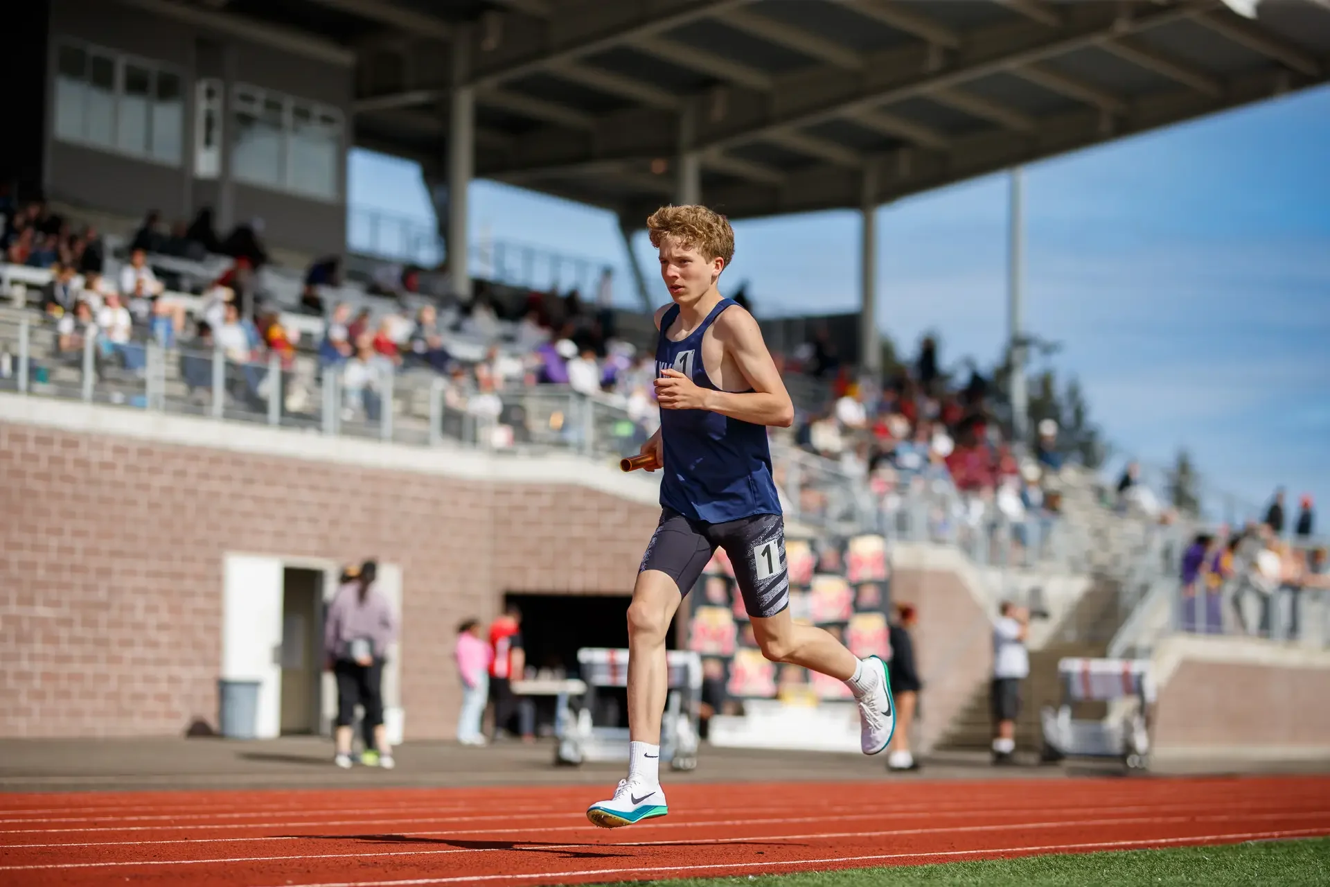 Freshman distance runner Quenton Lanese securing the relay handoff for Olympia High School at the Mt. Tahoma Track Festival in Washington.