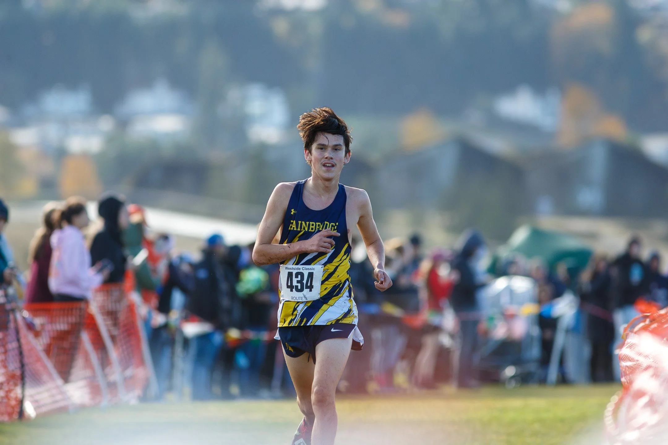 Bainbridge's Ryan Dodge running through a course lined with spectators
