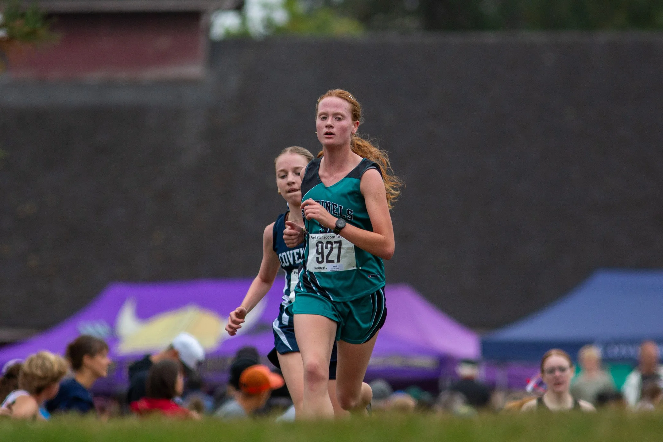 Spanaway Lake High School senior Isabelle Ackley (bib #927) competing in a cross country race at Fort Steilacoom Park.