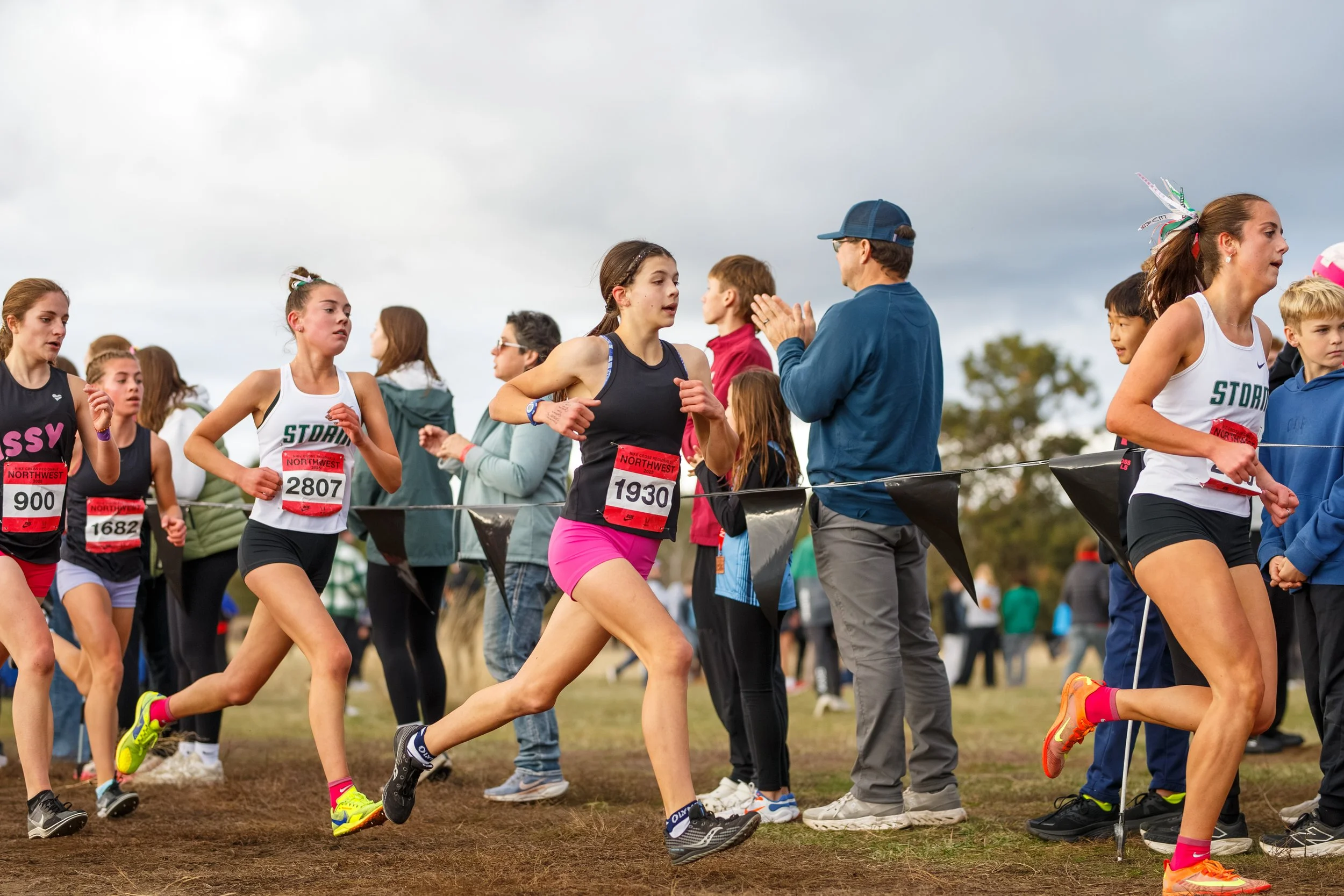 Gemma Stevick of Olympia High School competing in a cross country race at the 2025 NXR Northwest Championships, wearing a black Olympia uniform.