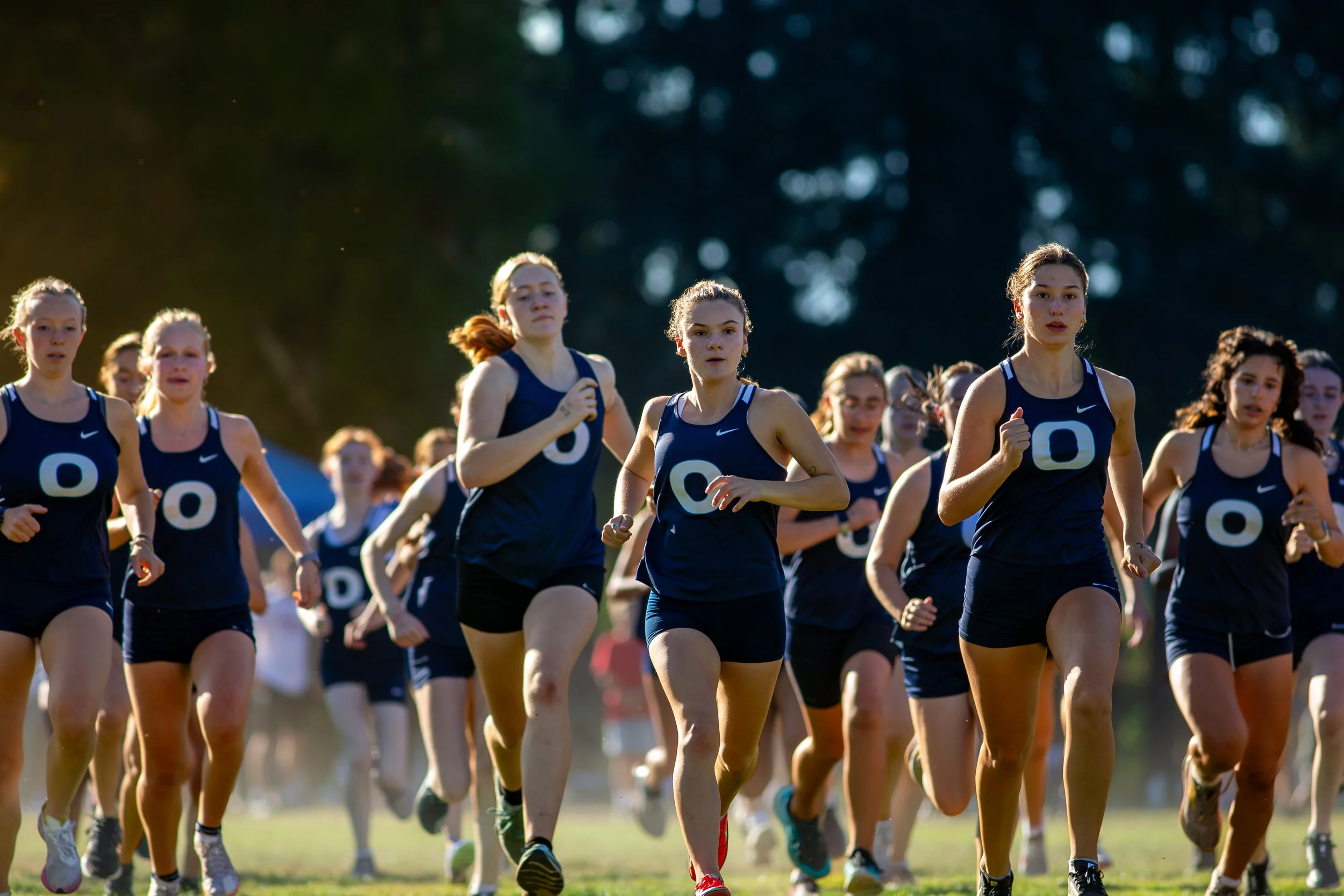 The Olympia Bears, a top 4A team contender, run in a tight pack. Their teamwork will be crucial in the competitive team race this weekend. In the 4A team competition, Olympia is a team to watch.