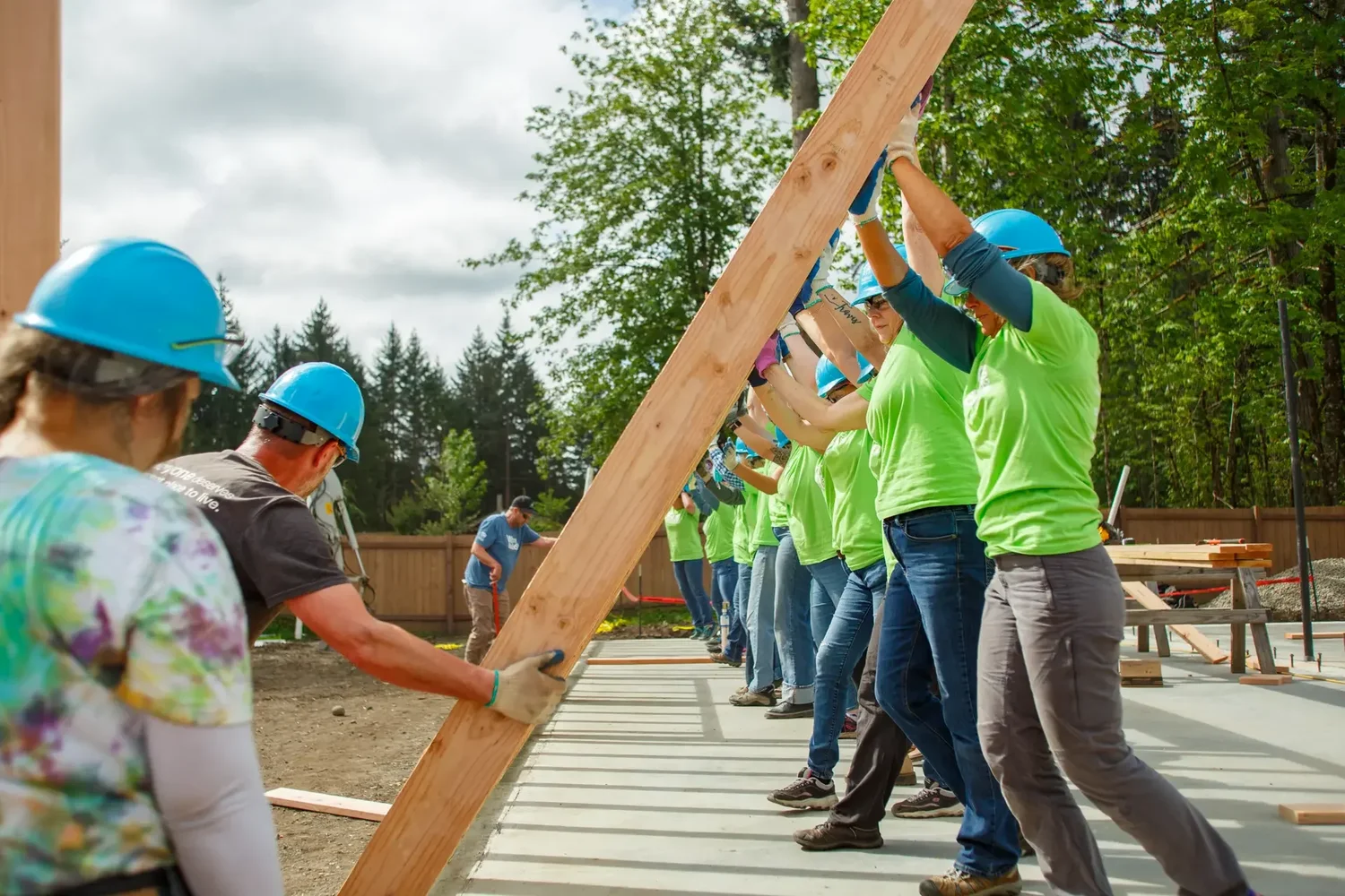 Volunteers raise a timber-framed wall during the South Puget Sound Habitat for Humanity Women Build in Olympia, Washington