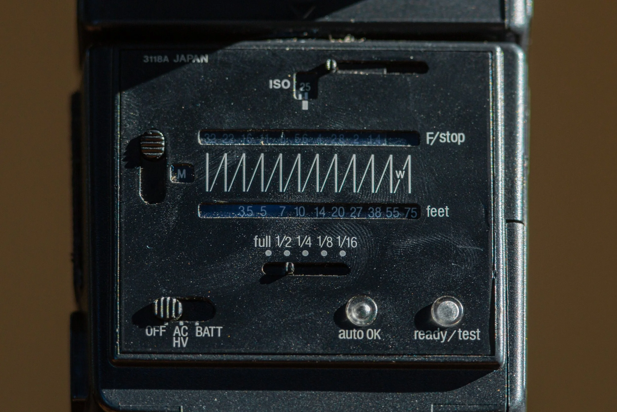 Sunpak 120J manual guide number calculator dial showing ISO, f-stop, and distance in feet