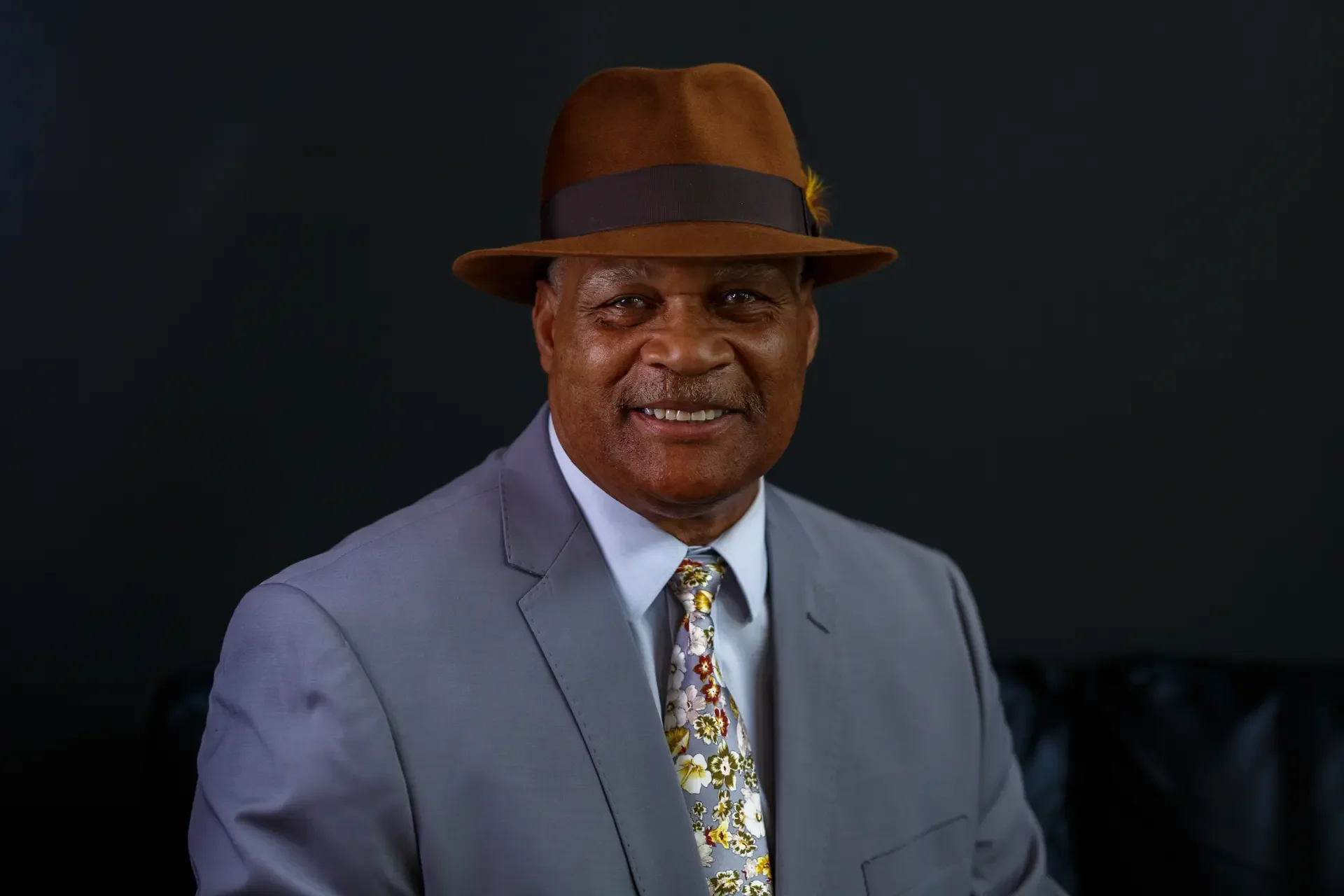 Professional headshot of a man in a suit and hat, shot with a mobile commercial studio setup for consistent Tacoma team photography.