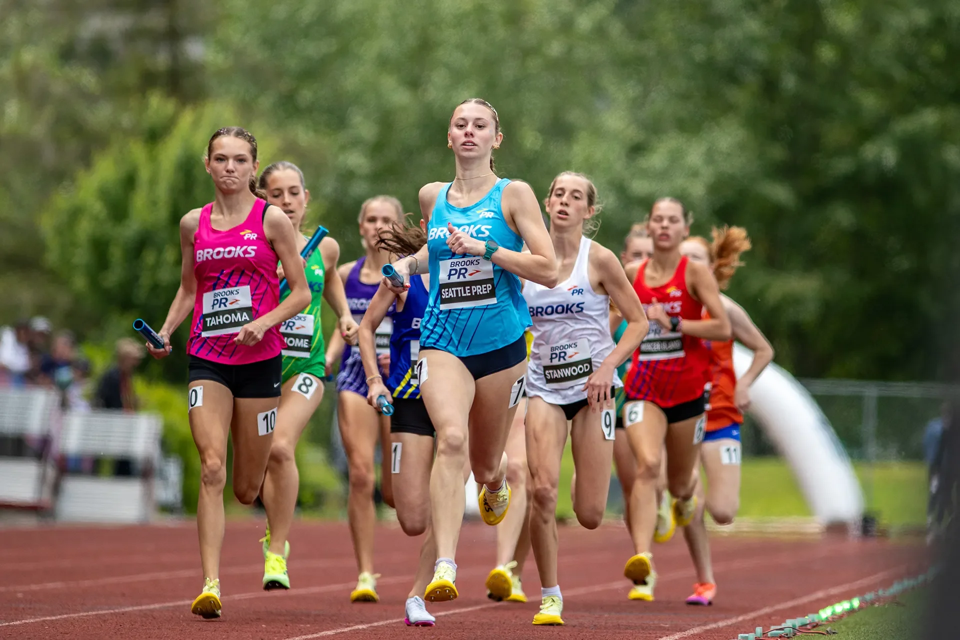 A Seattle Prep runner aggressively taking the lead after the first lap of the Washington-only Girls 4x800m relay at Renton Memorial Stadium.