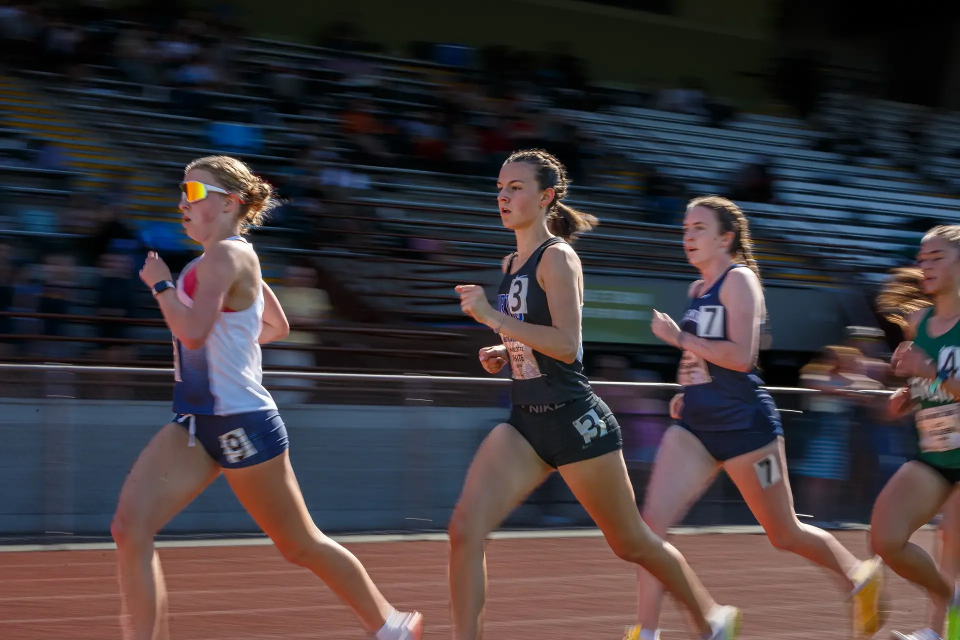 Charlotte White of Curtis High School running on a track. Top contender for the 2026 WIAA 4A 3200m State Championships.