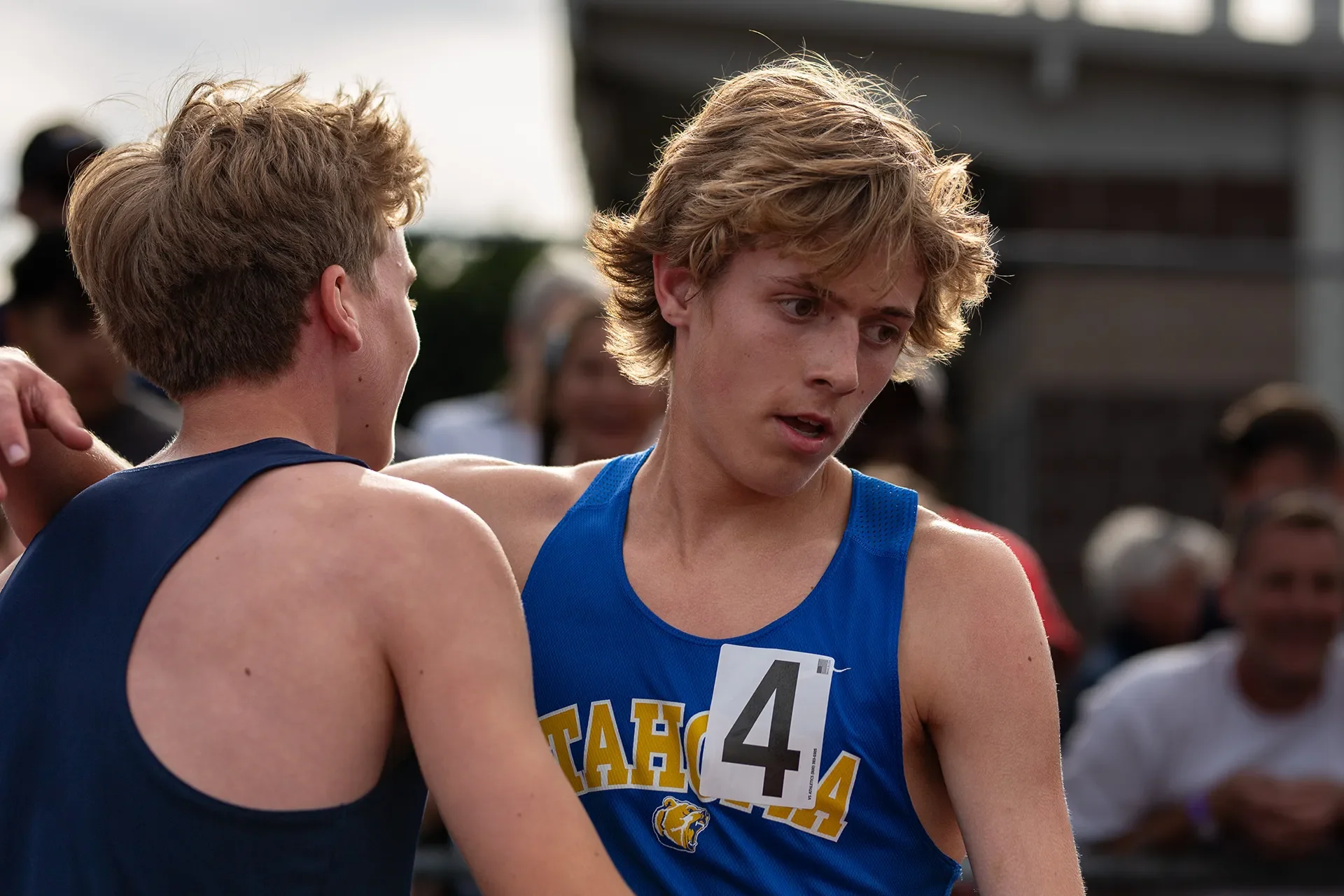 Olympia High School runner Quenton Lanese and Tahoma High School's Carson Stafford embrace on the track after the boys 4A 1600M championship.