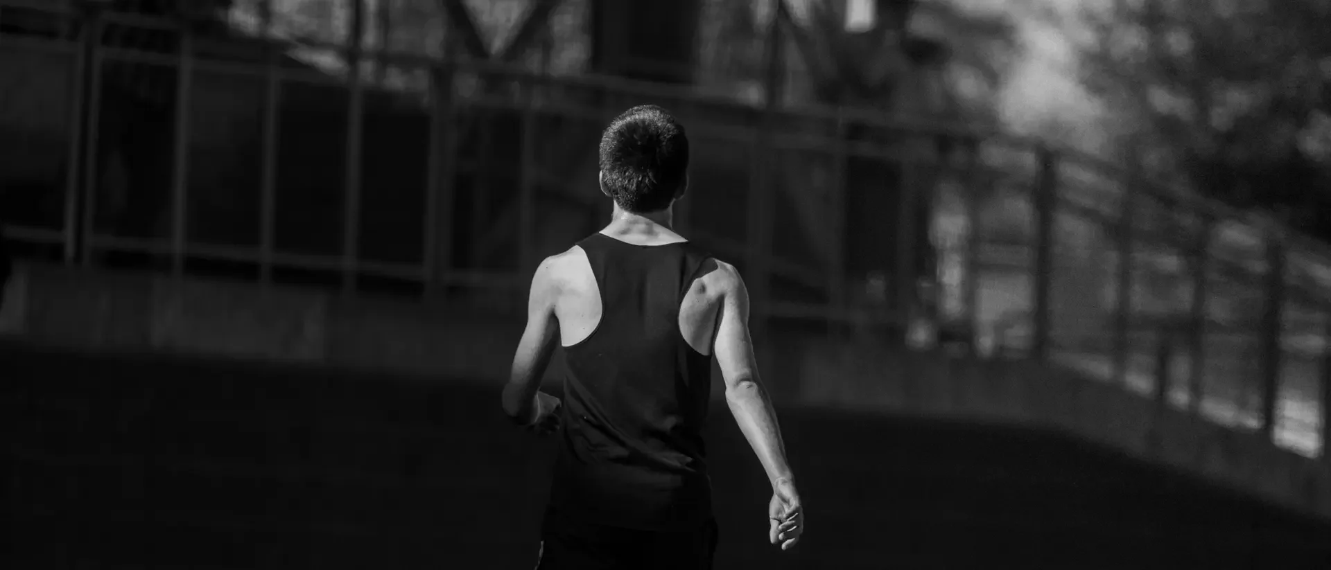 A male track athlete walks towards the grandstands.