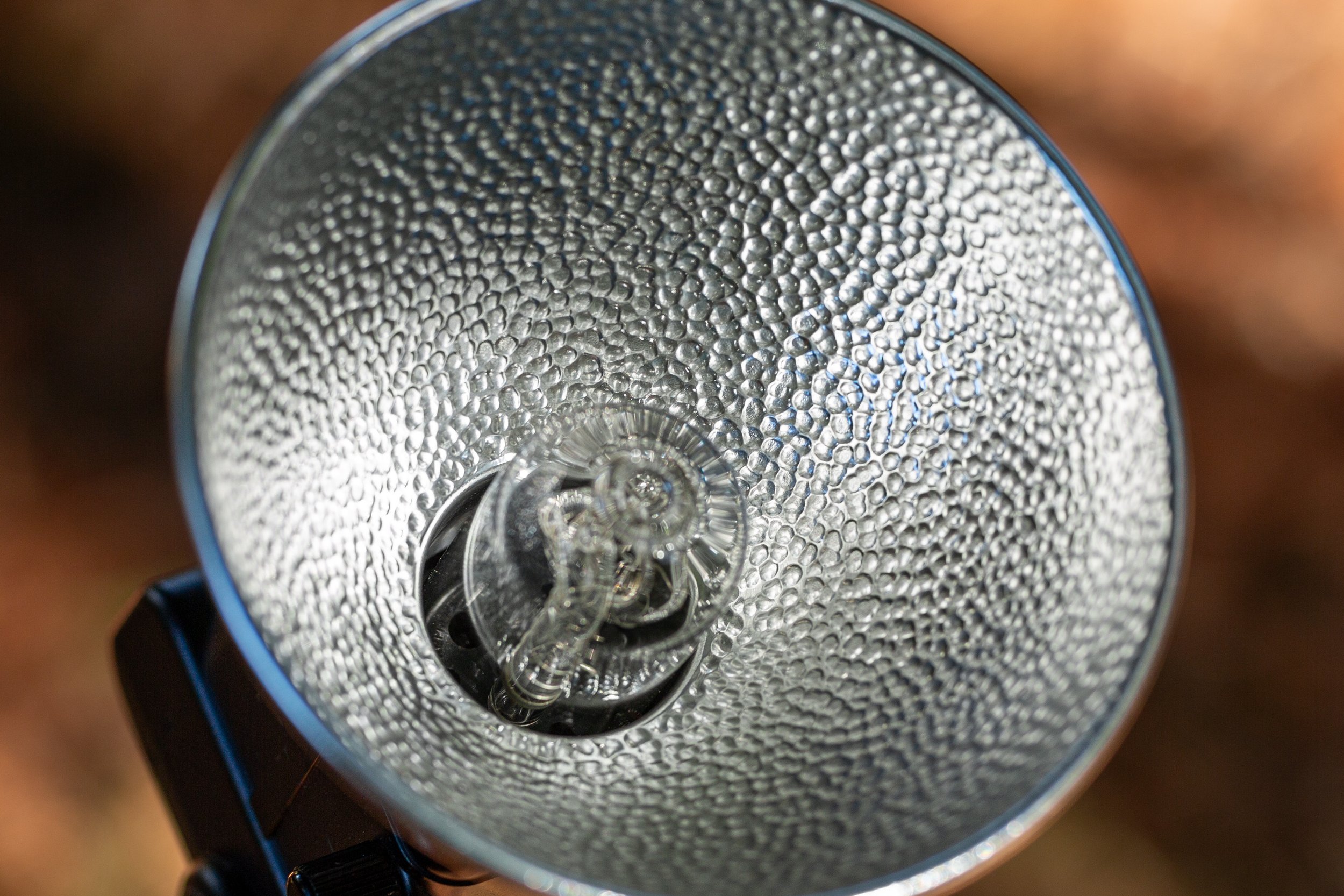 Close-up of the Sunpak 120J's flash tube and parabolic reflector, showing the bare-bulb design