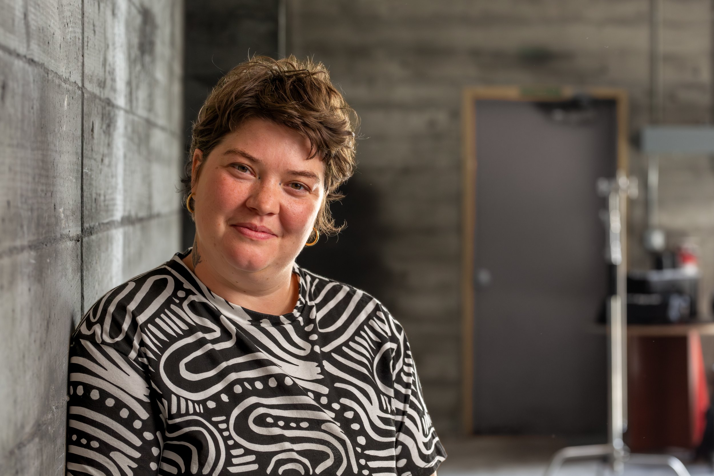 Portrait of Fern Tallos, muralist and artist, photographed at the Olympia, WA Armory.