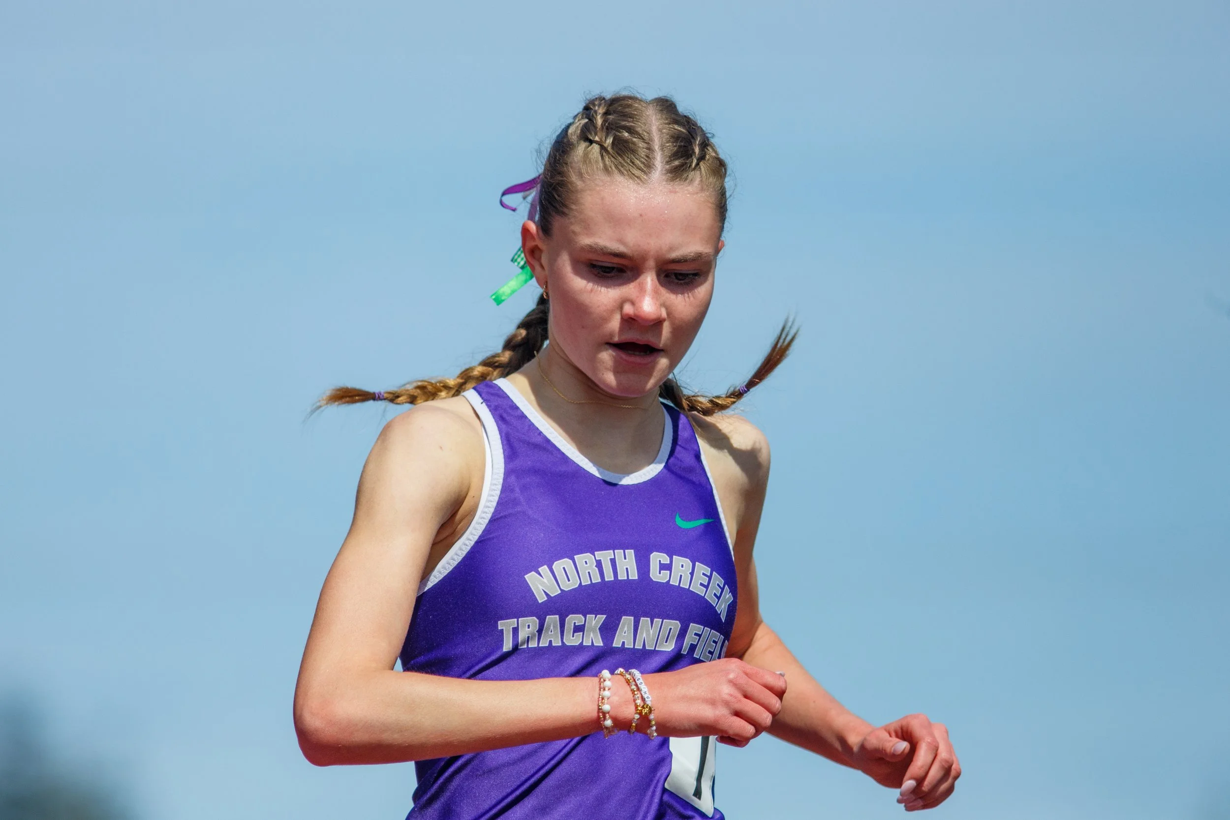 Amelia Wray finishing a race at the Olympia High School track by Russell Moore Photography.