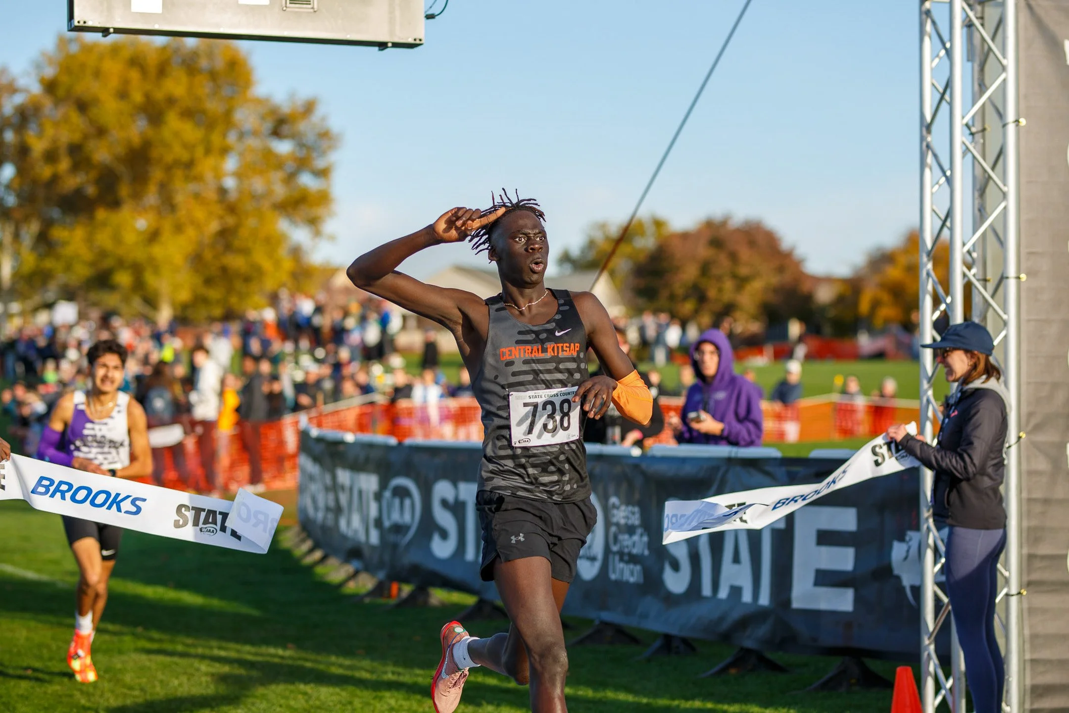Mana Voss of Central Kitsap breaking the tape to win his race at the WIAA cross country championships.
