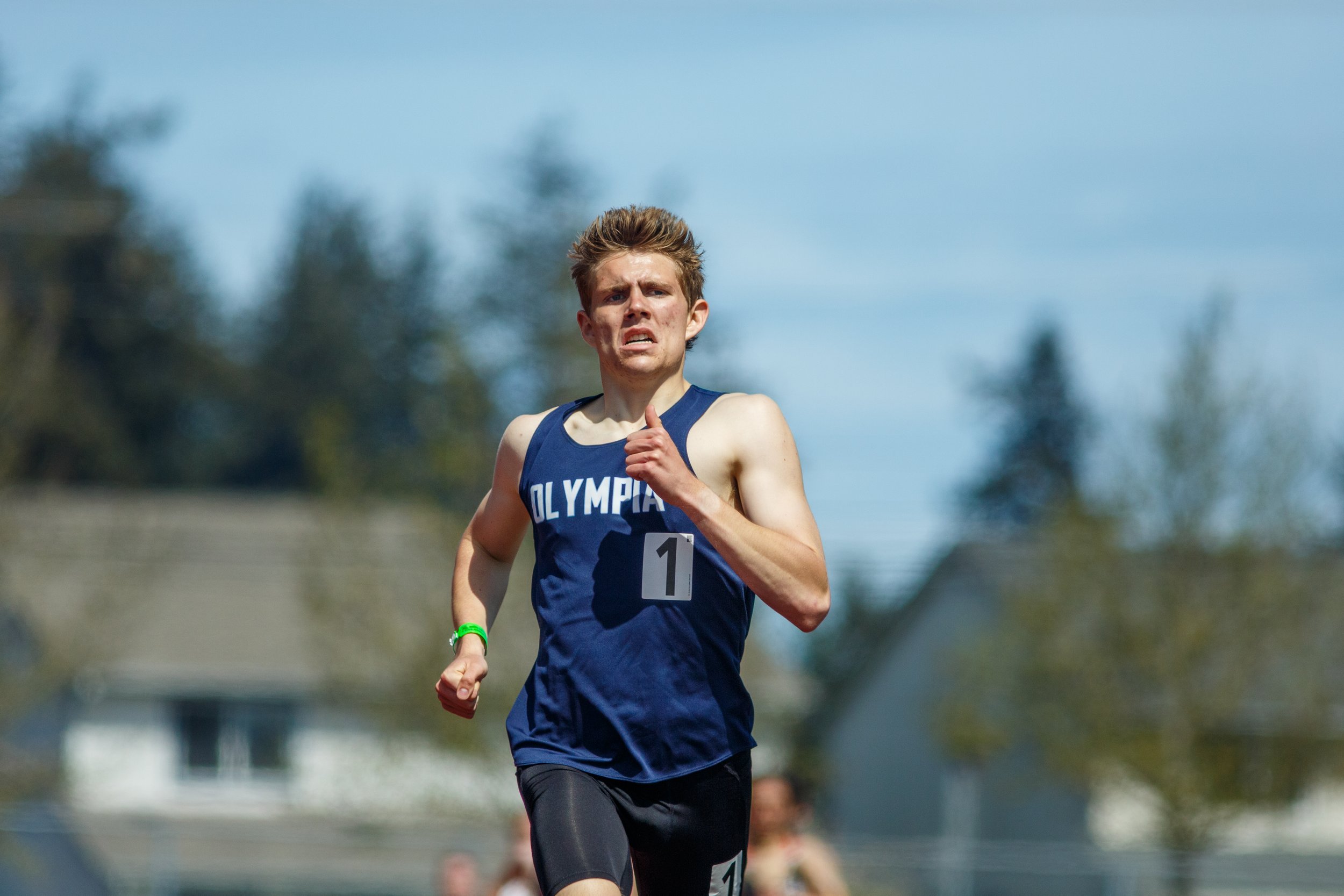 Olympia High School senior Caden Durocher running hard in a track event, featured in the elite 800m matchups preview for the 2026 South Sound Classic.