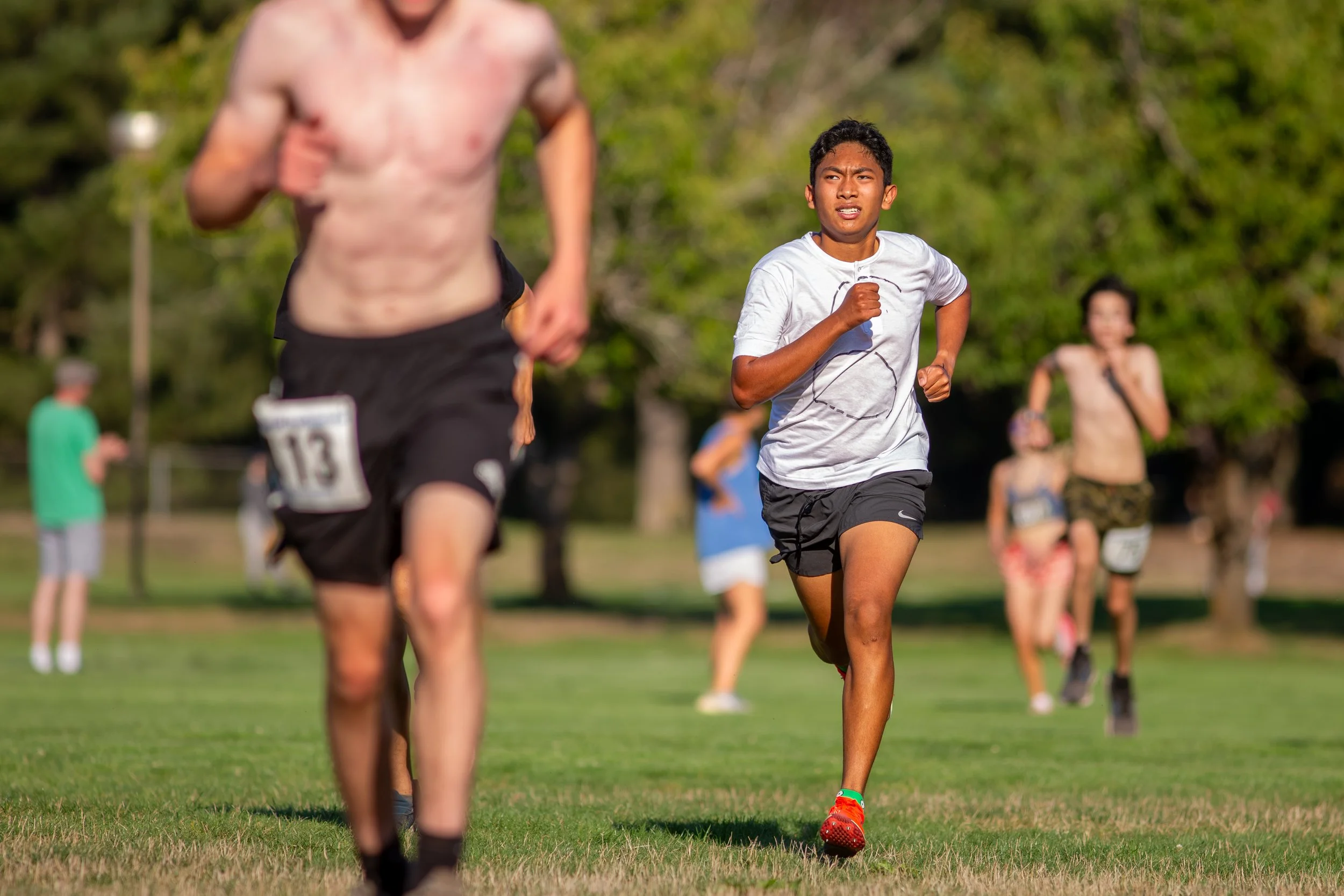 Elijah Cruz of Olympia High School finishing a cross country race at the 2025 Olympia Time Trials, running alongside another competitor.