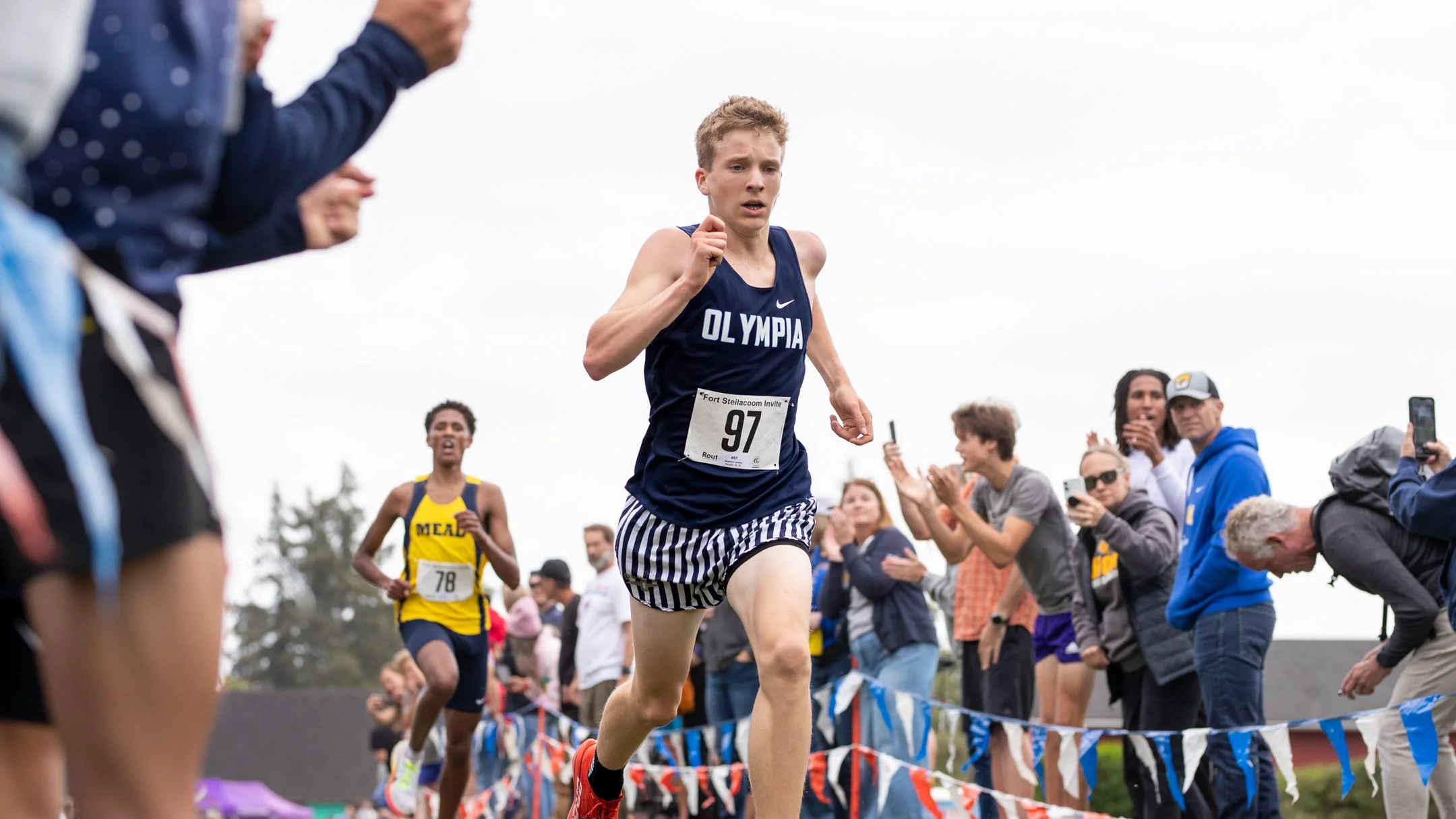 Olympia High School's Quenton Lanese leading a cross country race with Mead's Stejer Franklin close behind at Fort Steilacoom Park.