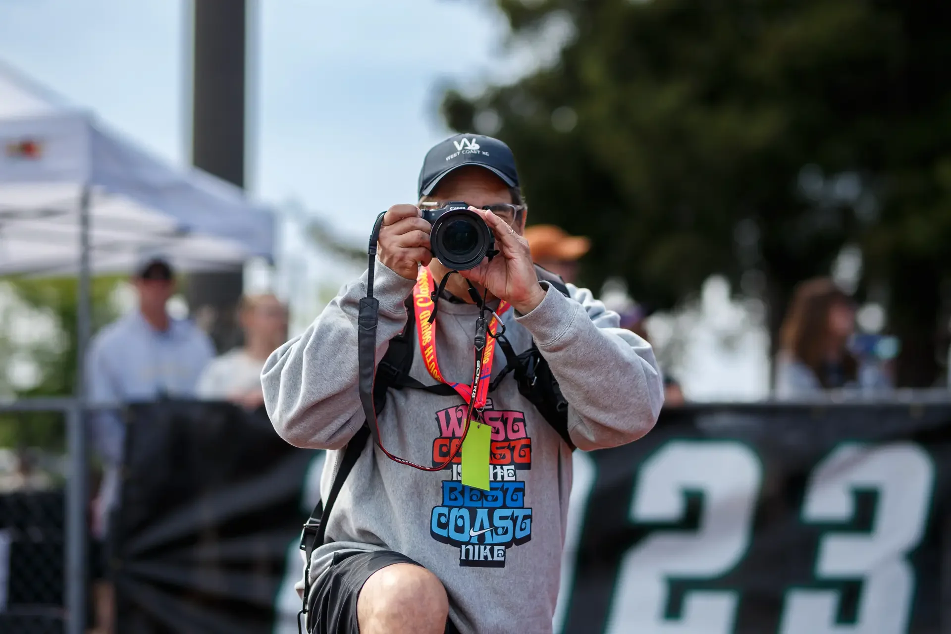 Ken Martinez of WestCoastXC taking a photo at Sparks Stadium in Puyallup, WA, photographed by Russell Moore Photography.