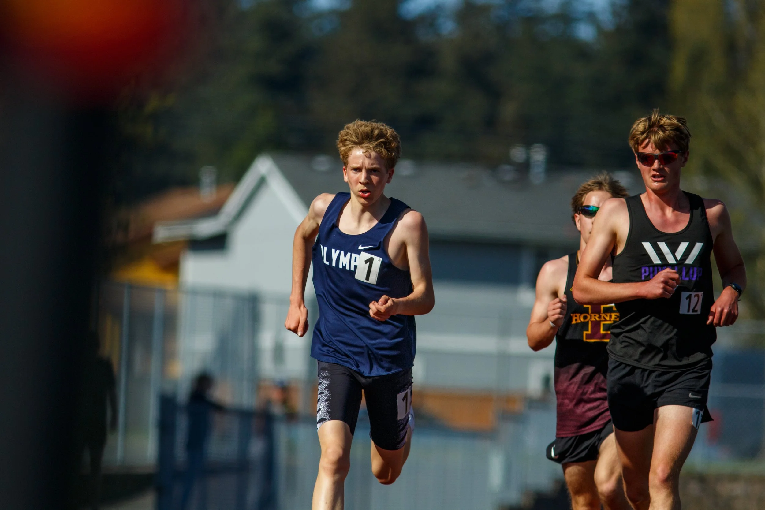 Olympia High School freshman Quenton Lanese surging ahead of the pack on the track, featured in the elite 1600m preview for the 2026 South Sound Classic.