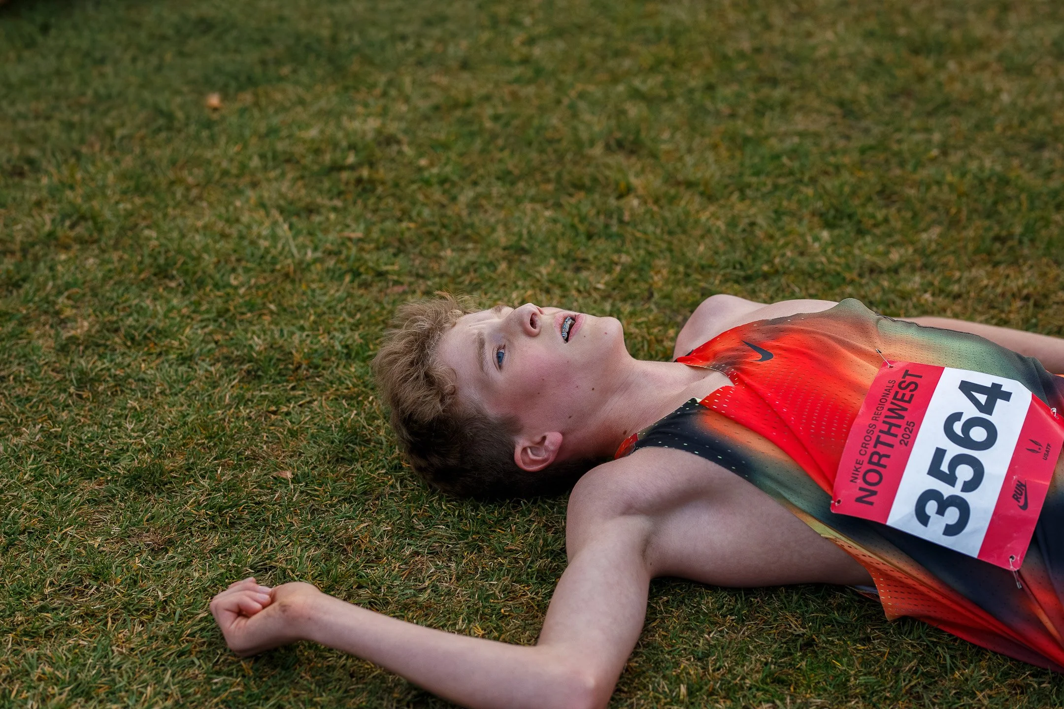 Quenton Lanese lying on the ground exhausted after his race at Nike Cross Regionals Northwest.