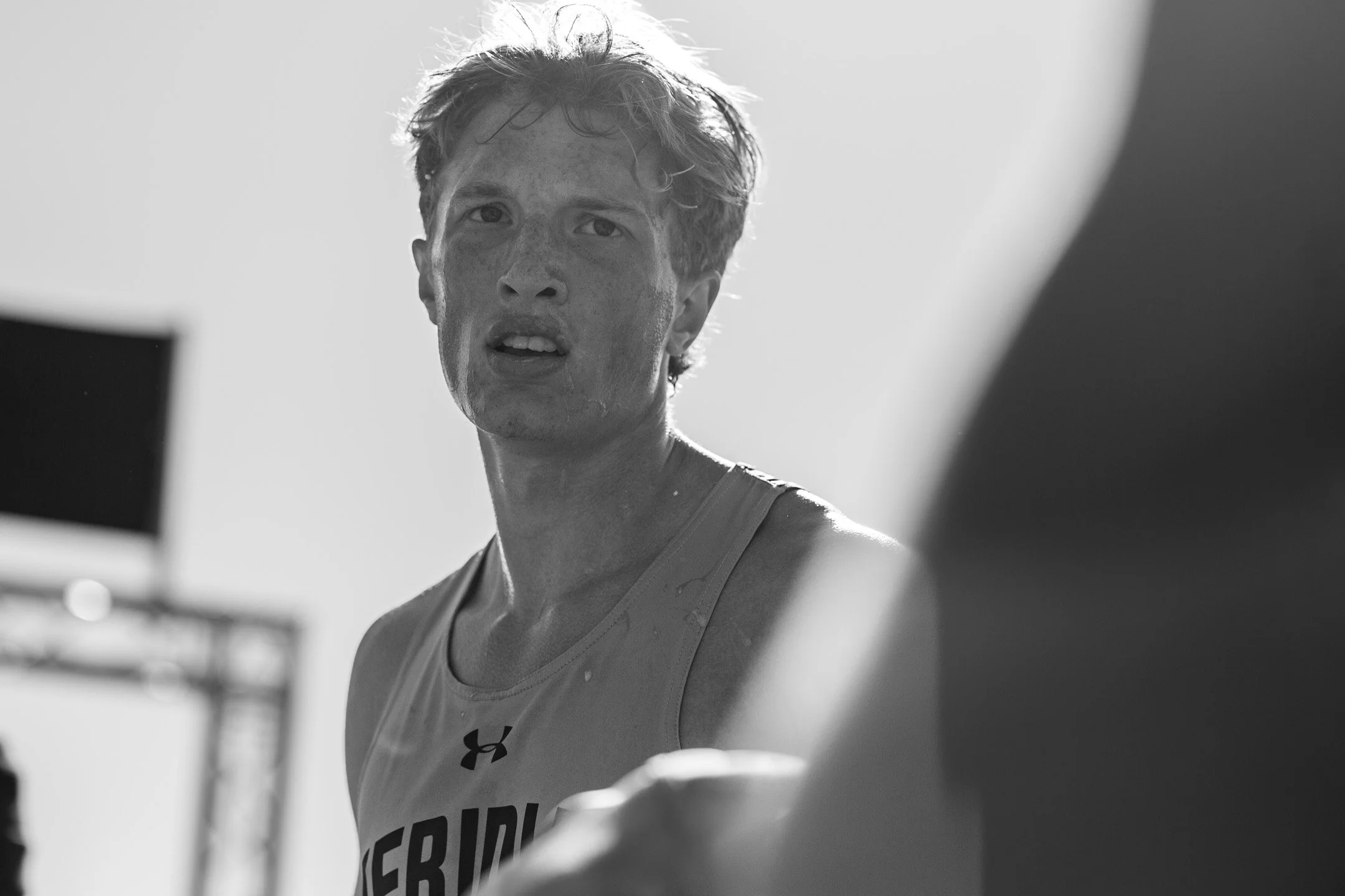 Black-and-white close-up of Meridian senior Reuben TeVelde, hair tousled, gaze fixed off-frame after the Danner Championship.