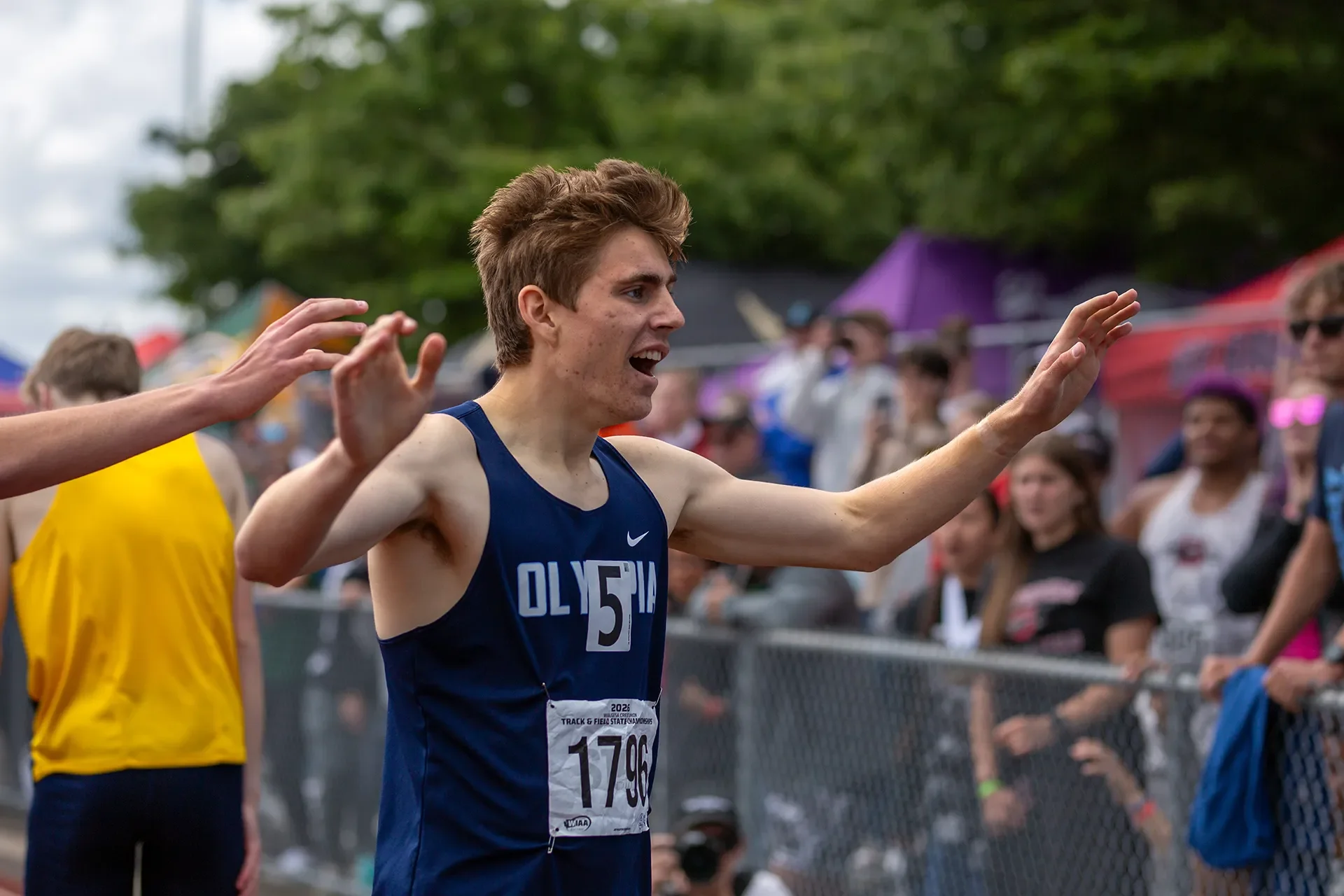 Caden Durocher of Olympia High School winning the 4A boys 800M state title in a photo finish against Amin Fidaar.