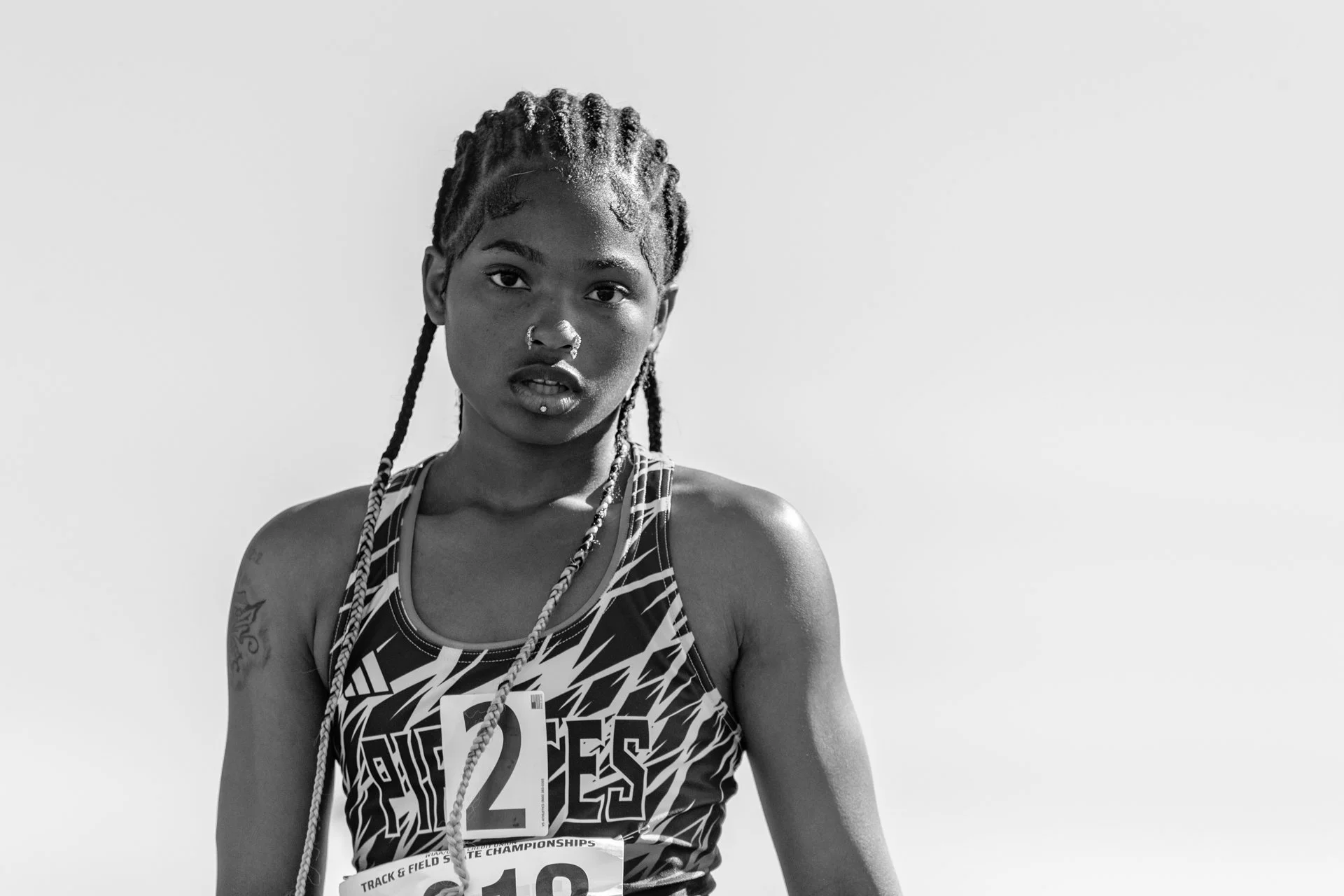Editorial senior portrait of a high school track athlete with braids, representing diversity in Thurston County sports.