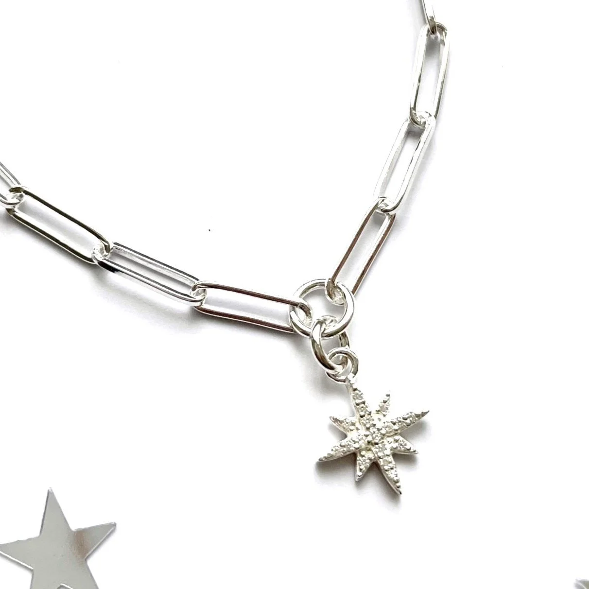 Silver chain necklace with a sparkling star-shaped pendant