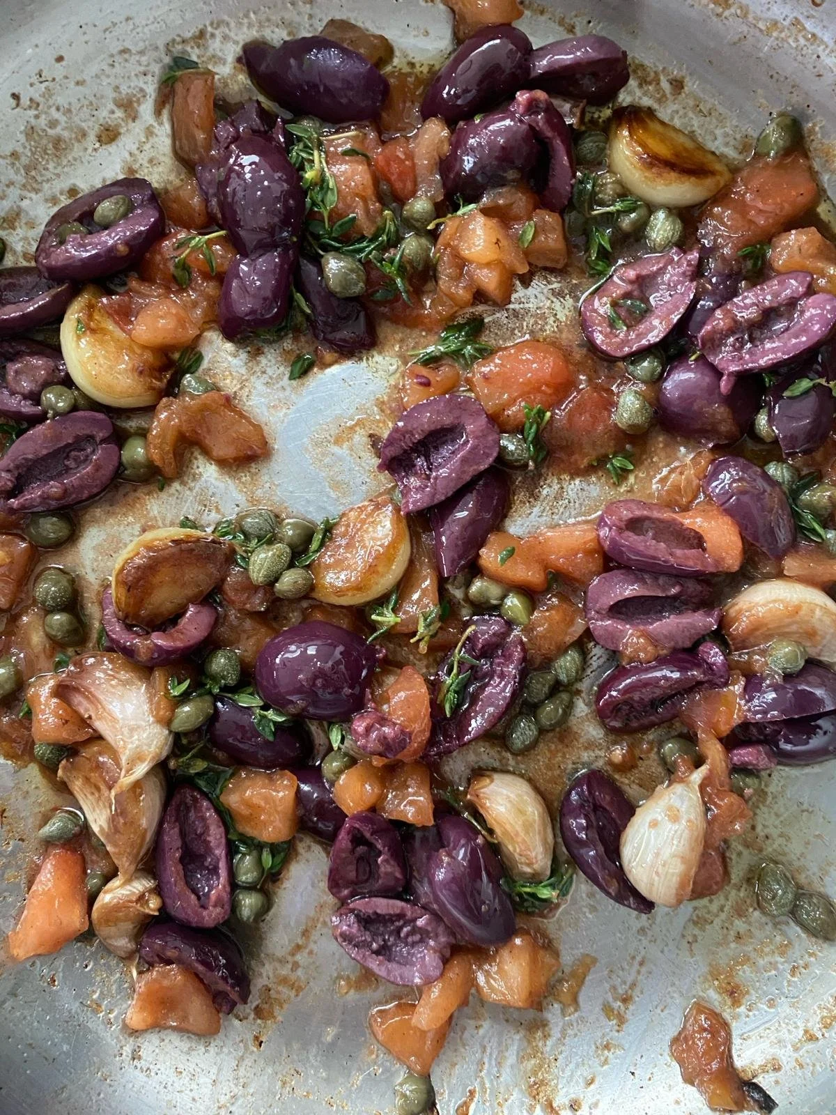 add tomatoes, capers, olives, thyme …