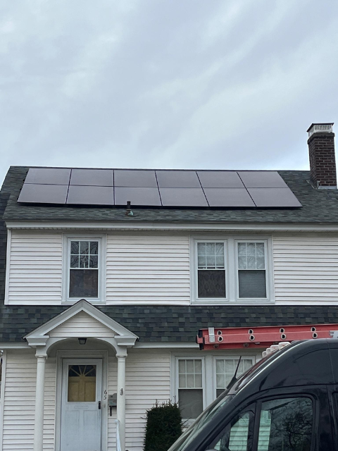 Completed Greenfield solar installation featuring high‑efficiency solar panels on a residential roof.