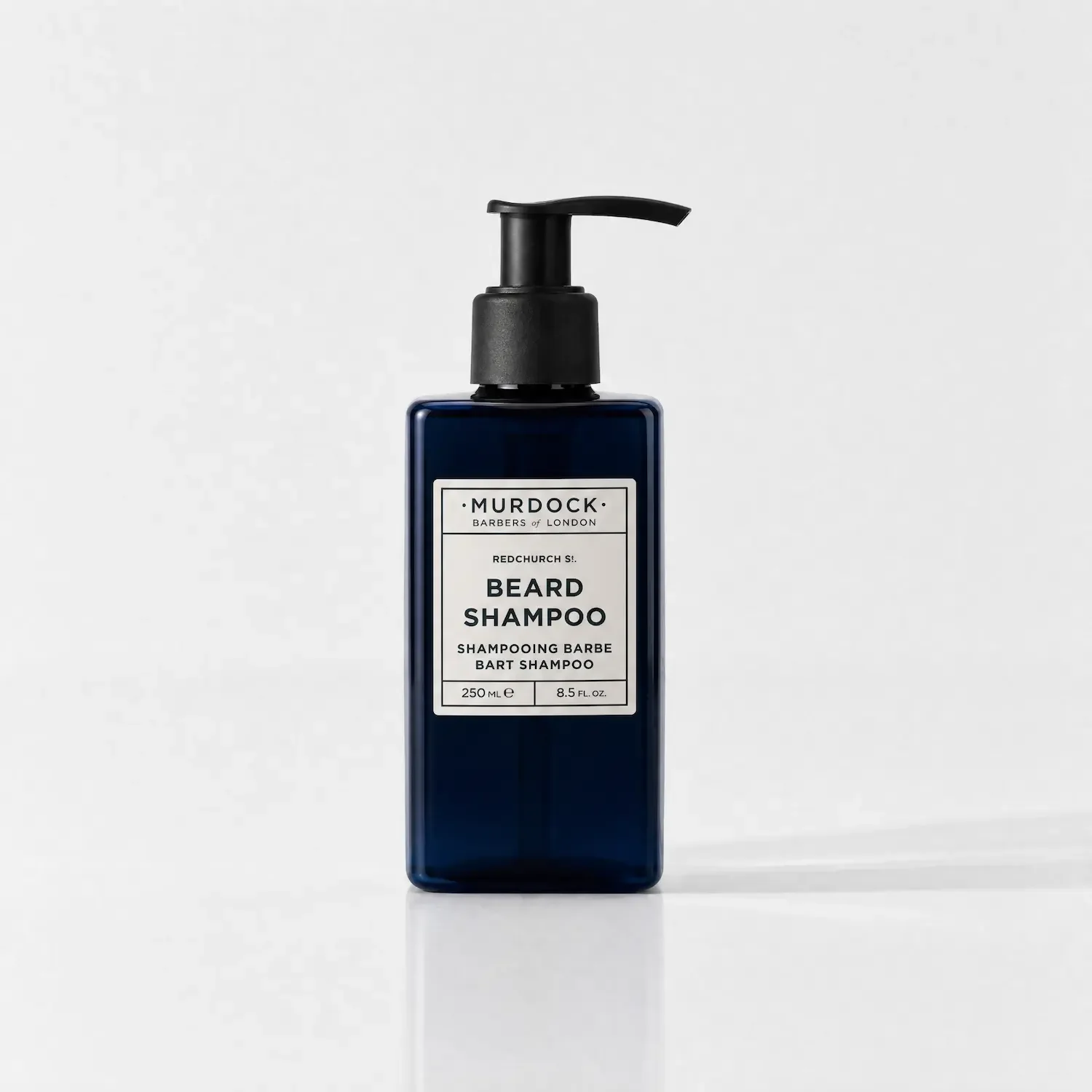 Black bottle of Murdock Beard Shampoo with pump dispenser on a white background