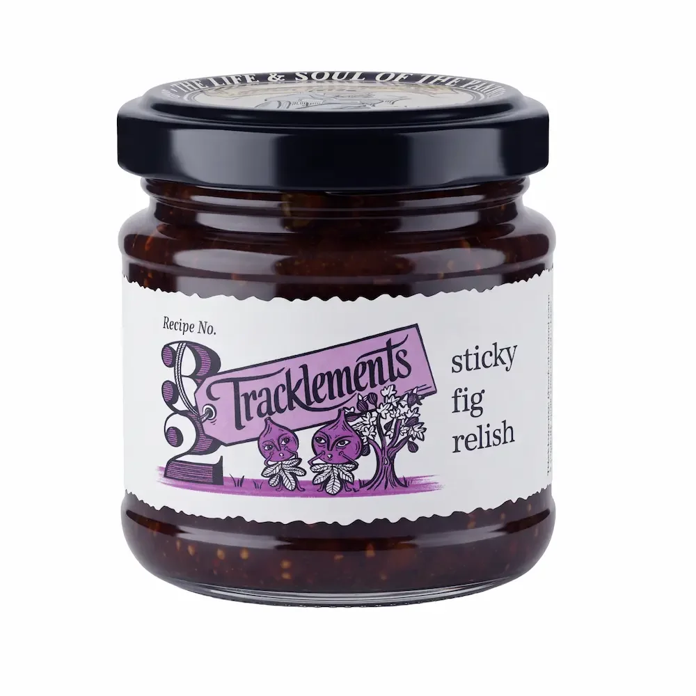 Packshot of a Jar of Tracklements sticky fig relish with illustrated label and black lid on a white background