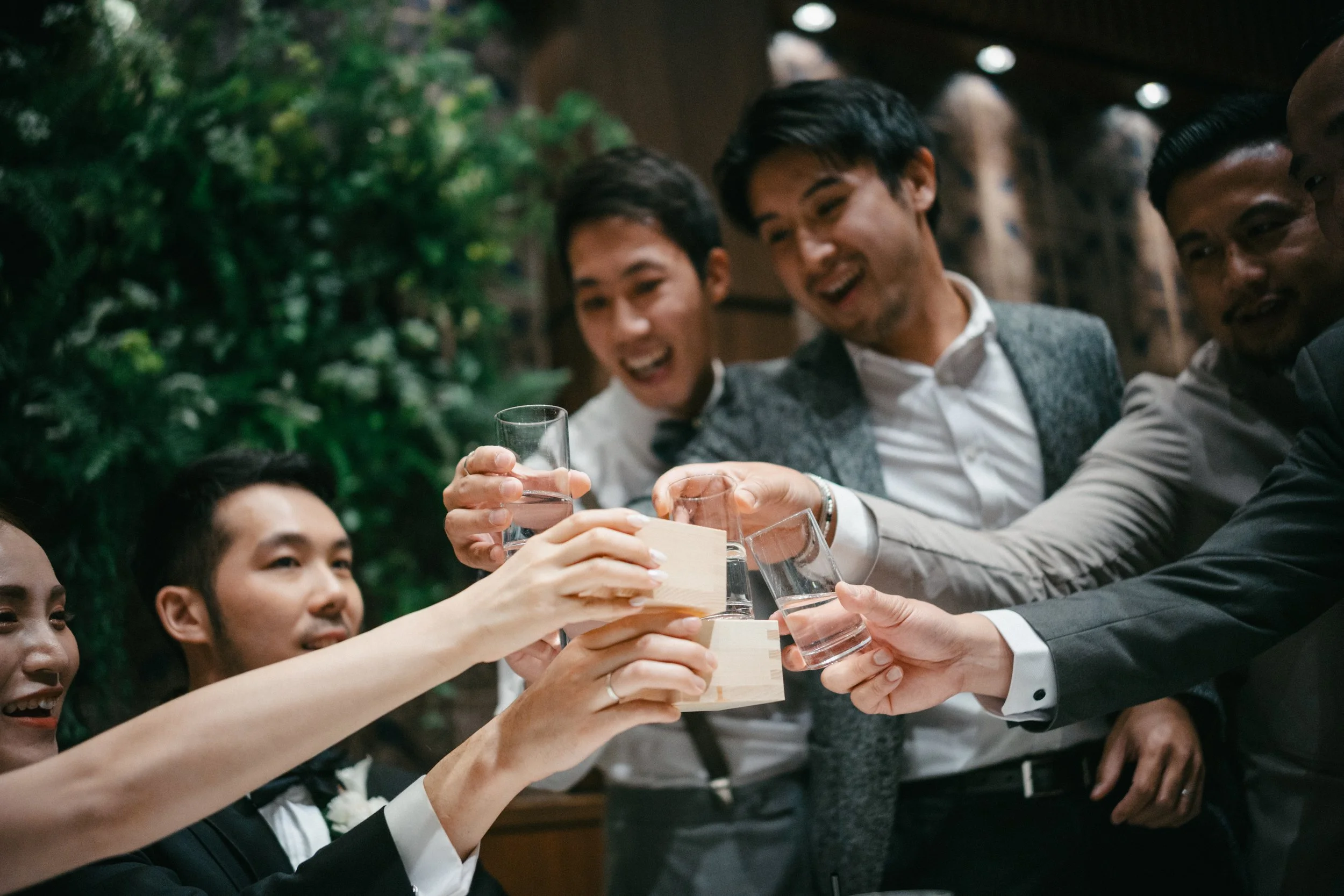 Group of friends raising glasses in a toast at a celebration.