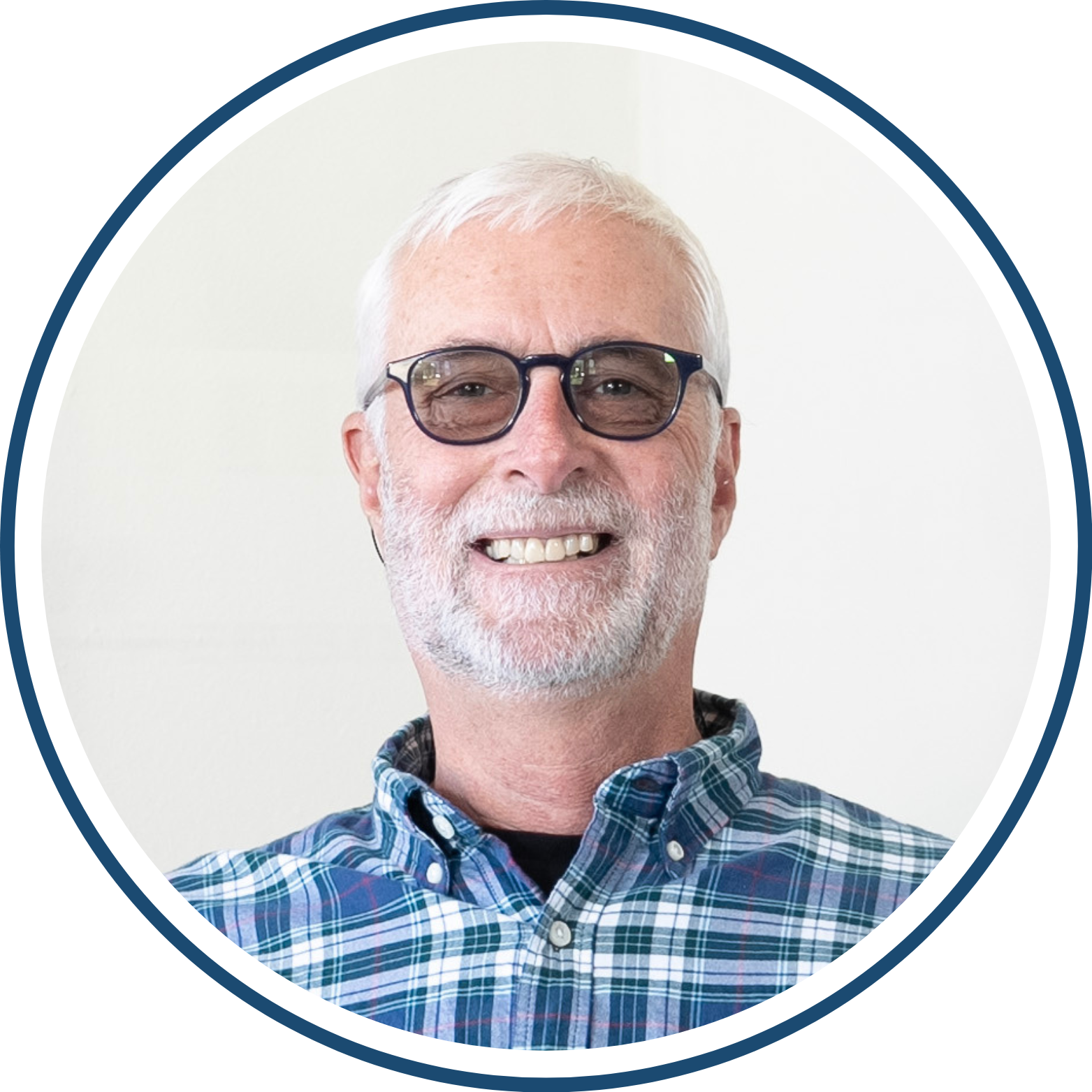 Smiling man wearing glasses and plaid shirt