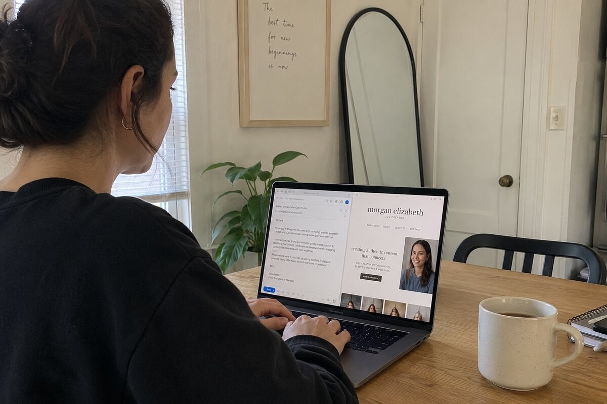 Creator drafting a brand pitch email on a laptop, with a UGC portfolio open in another tab
