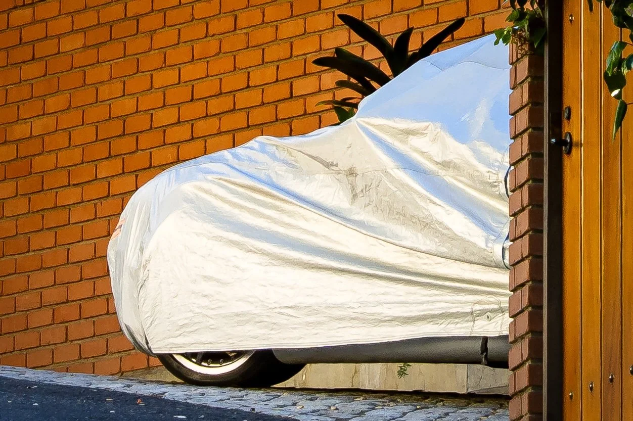 Car under cover against brick wall.jpg