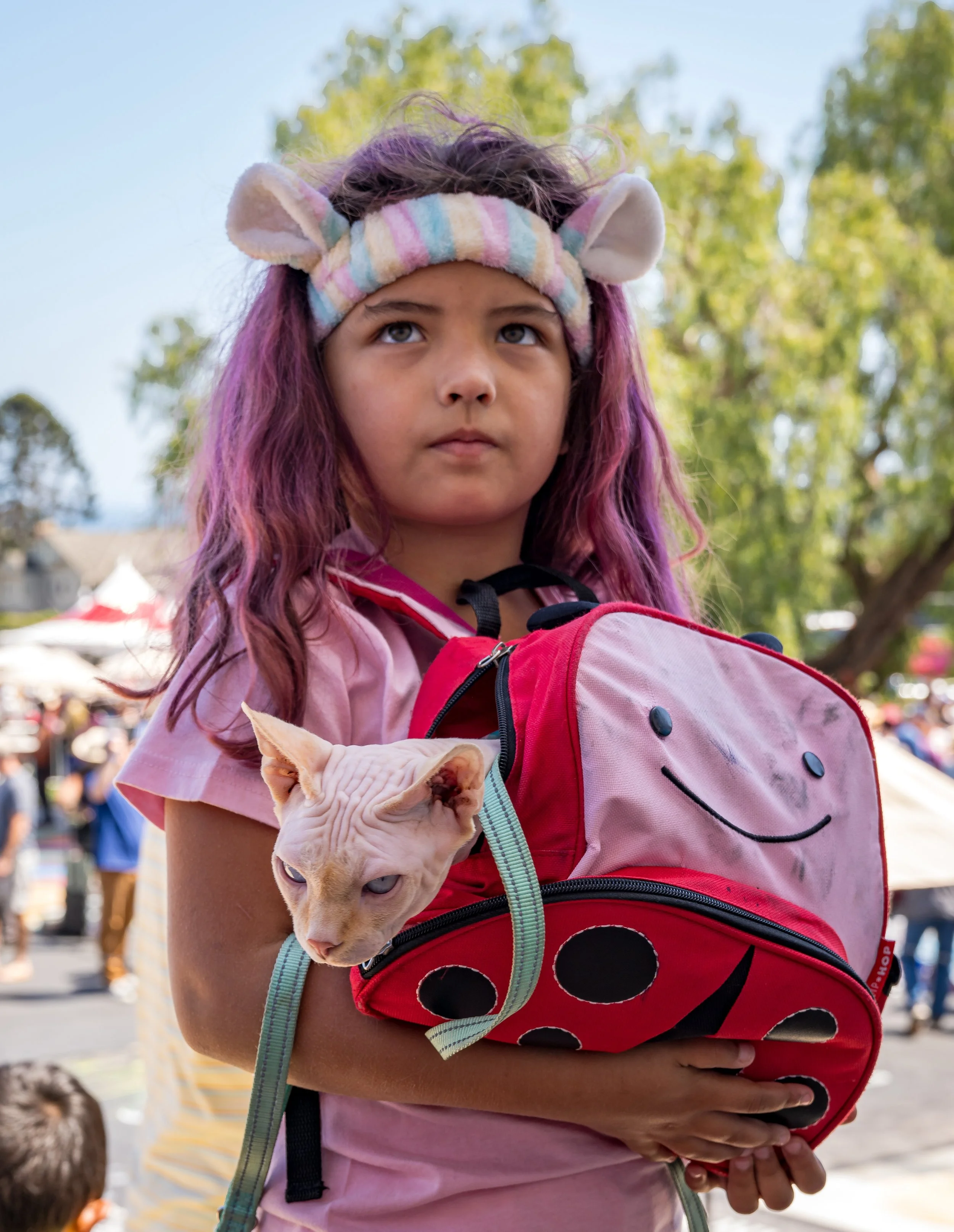 Girl with hairless cat in smiley bag.jpg