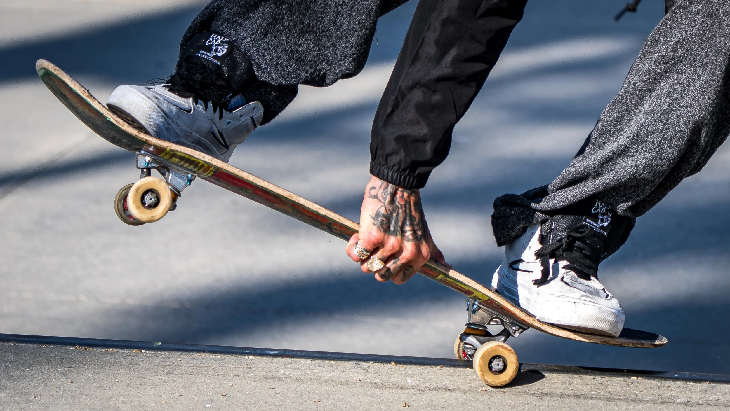 Skateboarder holds board close-up.jpg