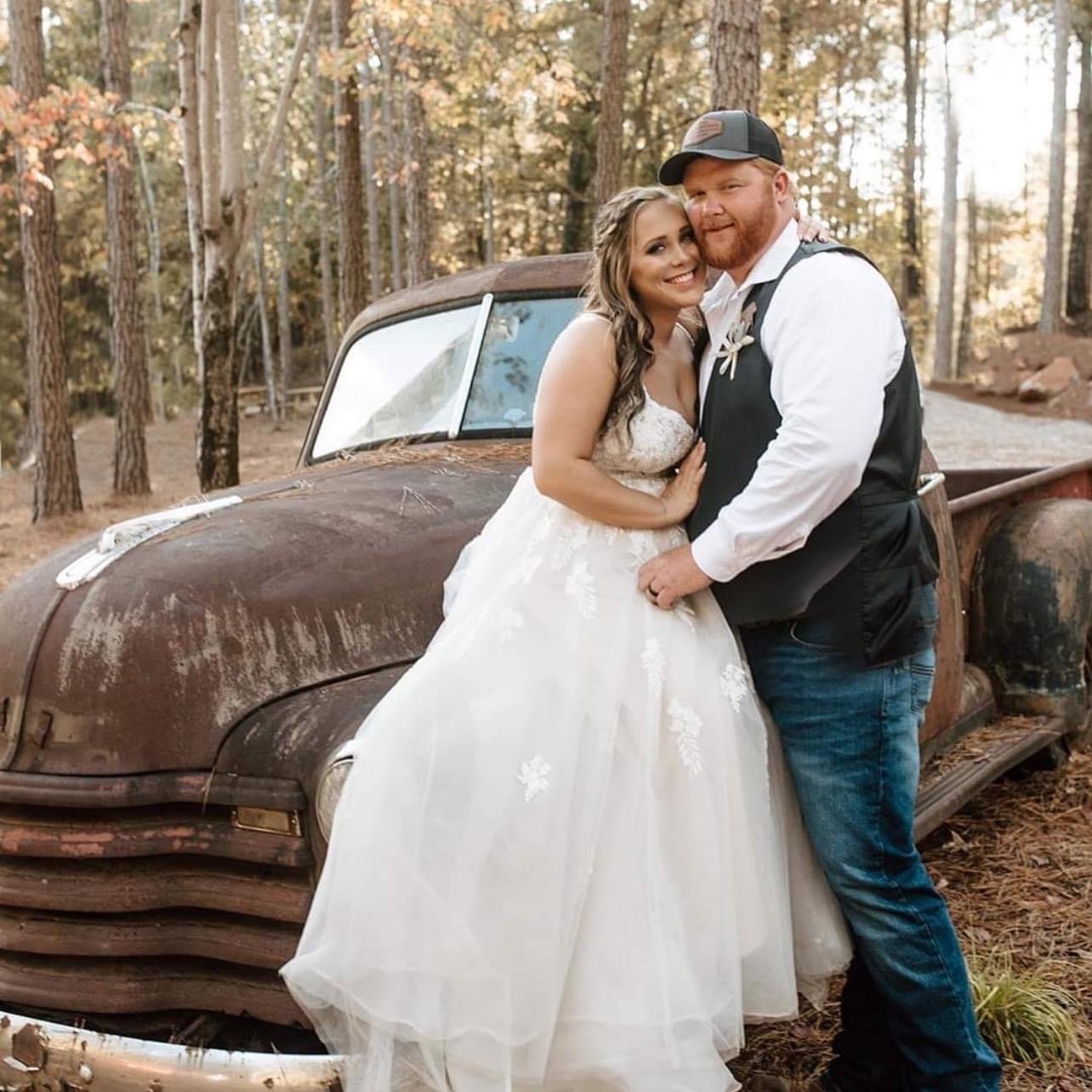 Laurie’s customers, Fernando and Kate embracing by the lake on their wedding day.
