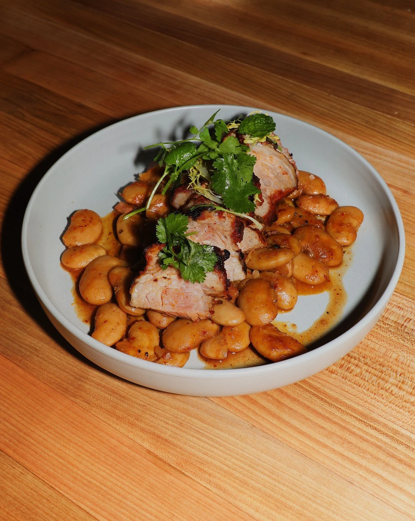 A dish that melts in your mouth. Grilled and tender pork shoulder, deeply savory and paired with gigante beans. Finished with dandelion, jus, and Calabrian chili heat. 

Happy new year folks, we look forward to having you in! ✨

#seattlerestaurant #g