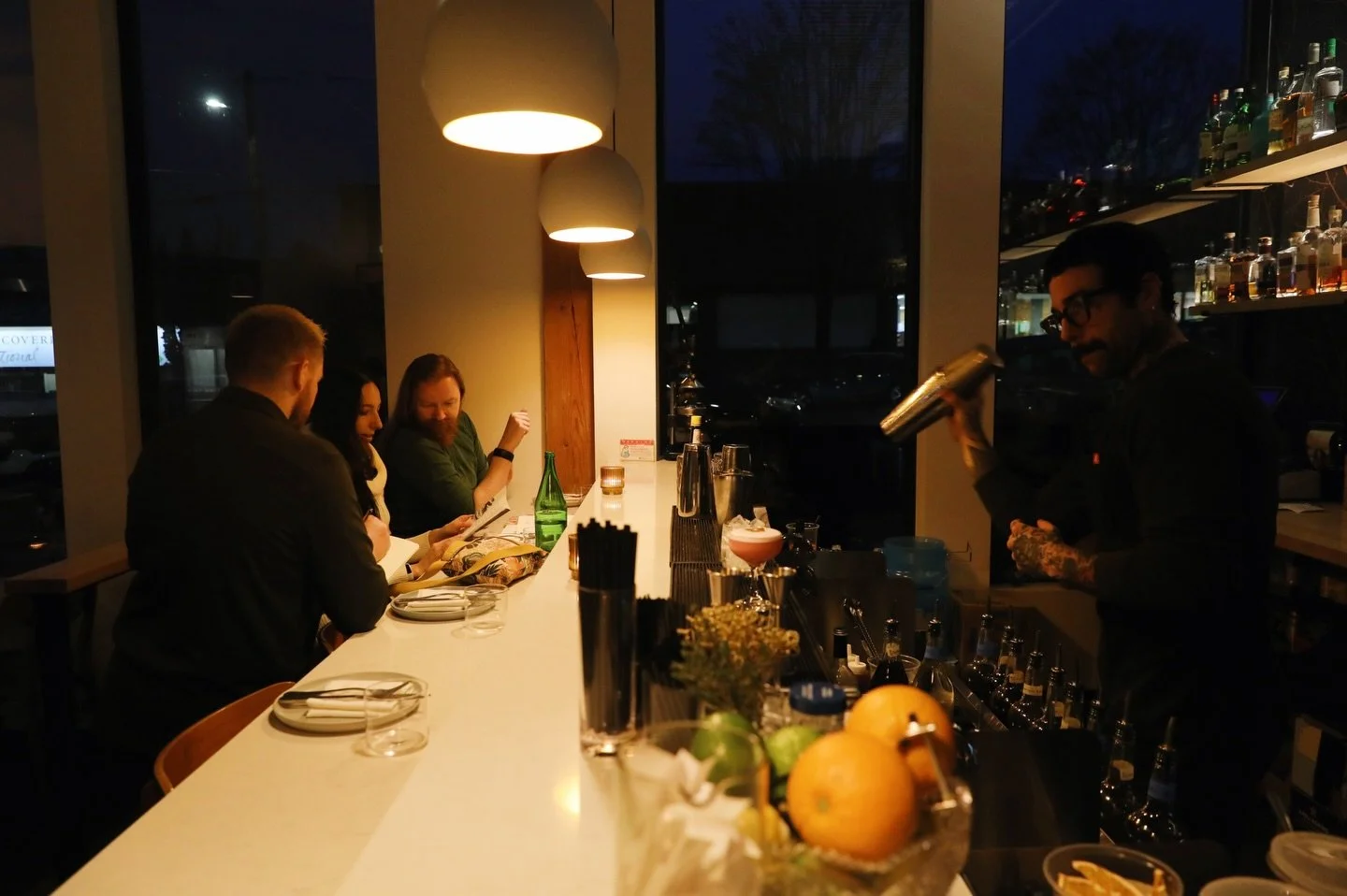 Our favorite seat in the house is at the bar, under the warm glow of the hanging lights. 

It&rsquo;s where the room feels most alive. Drinks come together within reach, conversations start easily, and our team gets to know the guests sitting across 