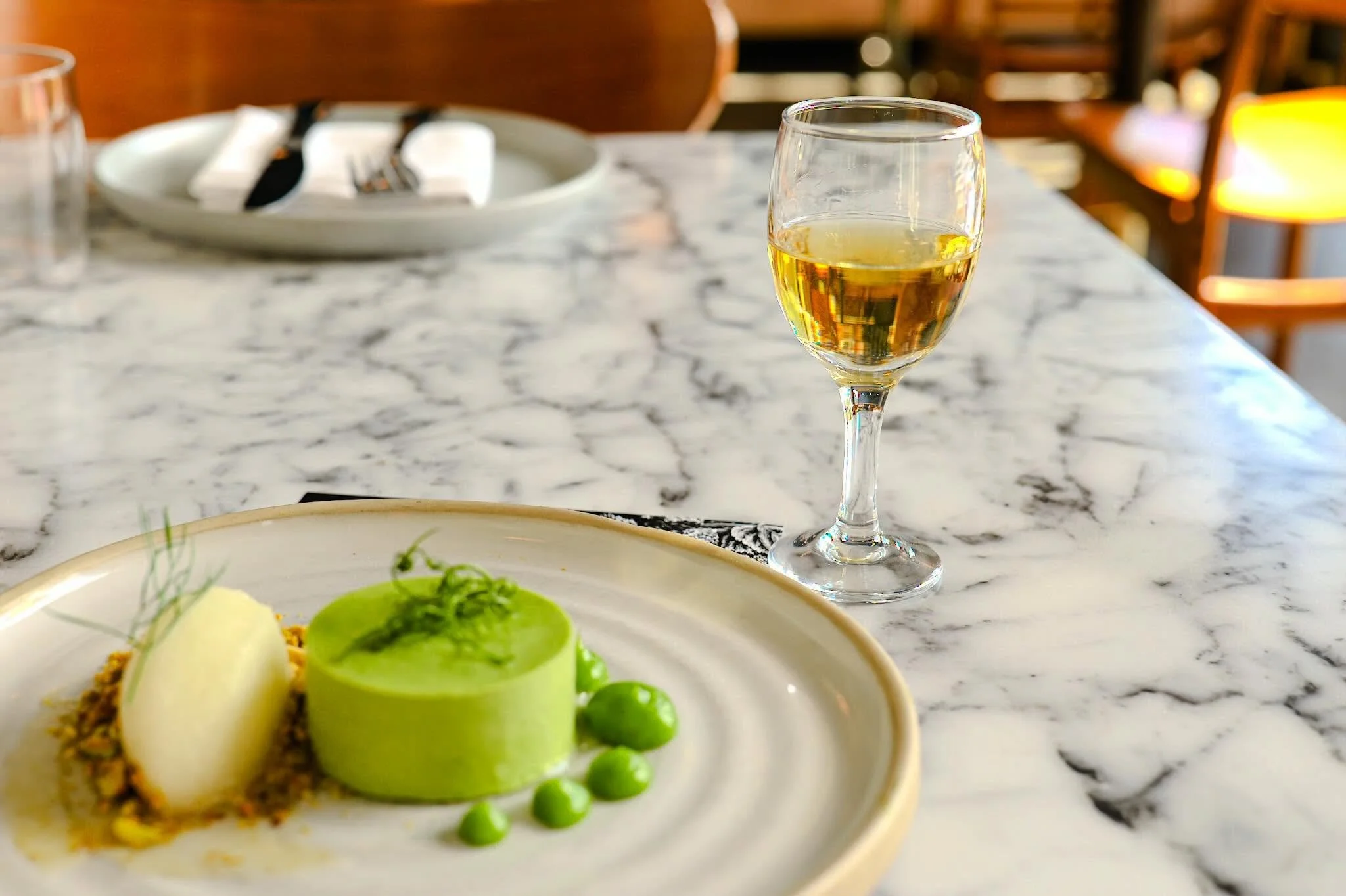 A perfect ending to Chef&rsquo;s latest tasting menu. Soft herb panna cotta with sweet pea, pistachio, fennel sorbet along with a few sips of @fastpennyspirits Amaricano Blanco 🤌🏼.