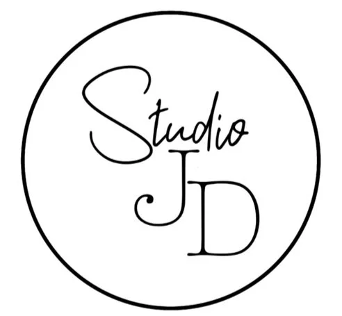 Black and white logo with the words 'Studio JD' inside a circle.