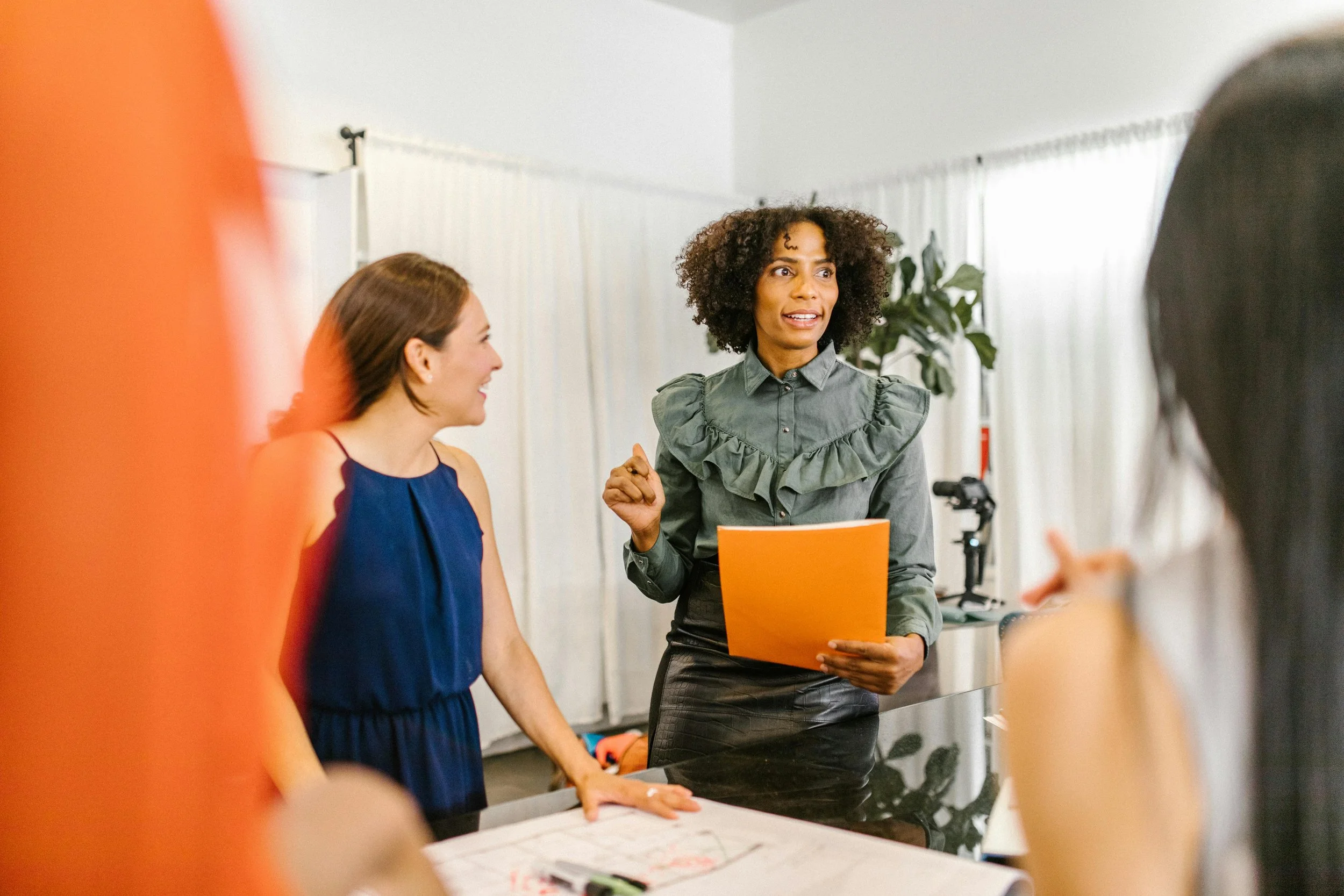 A woman leader running a meeting with her employees