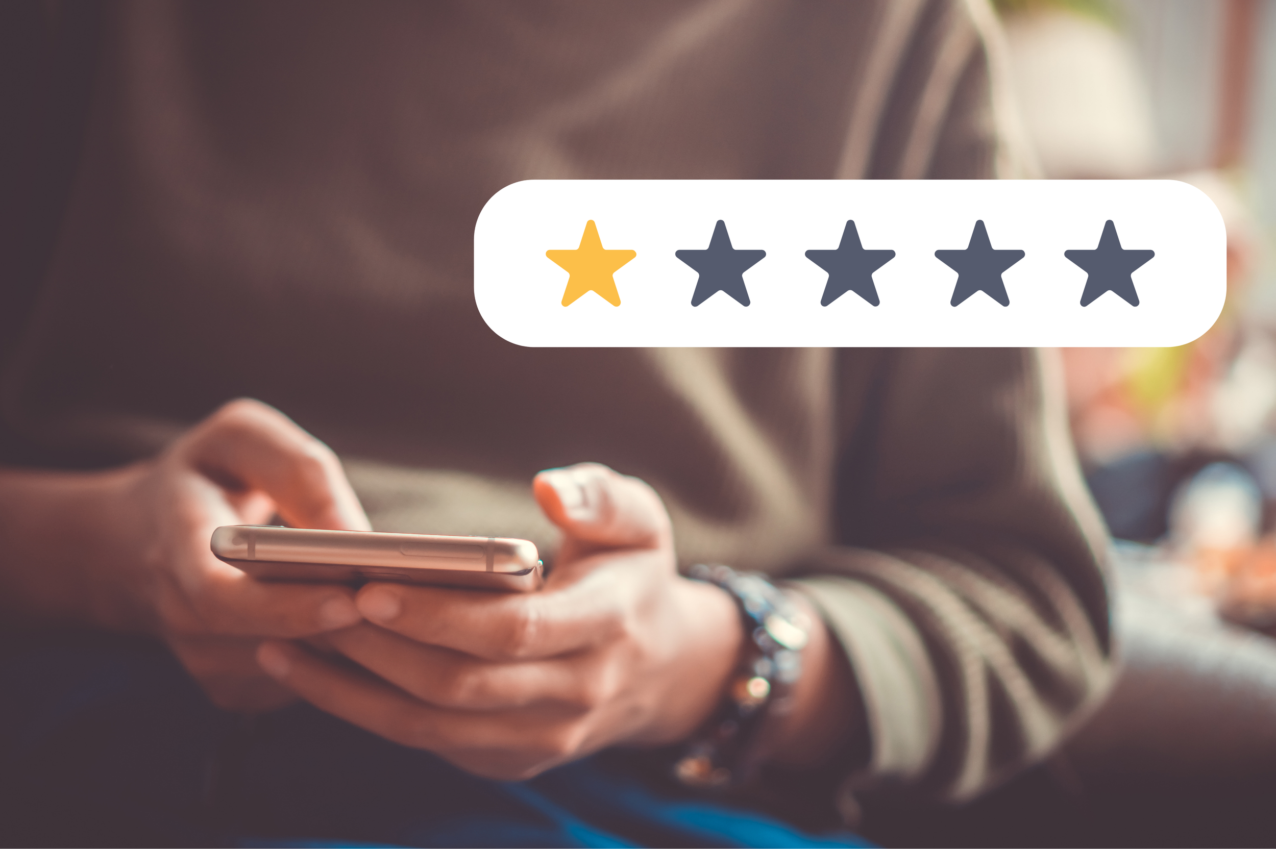Person holding phone leaving a 1-star review