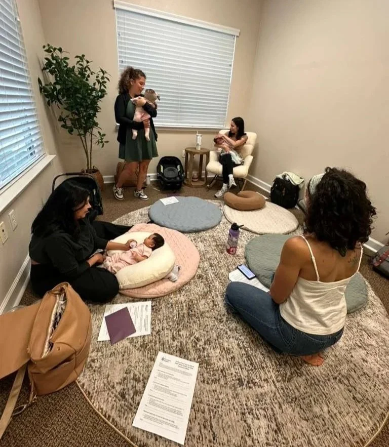 Lactation consultant supporting a parent and newborn with feeding guidance