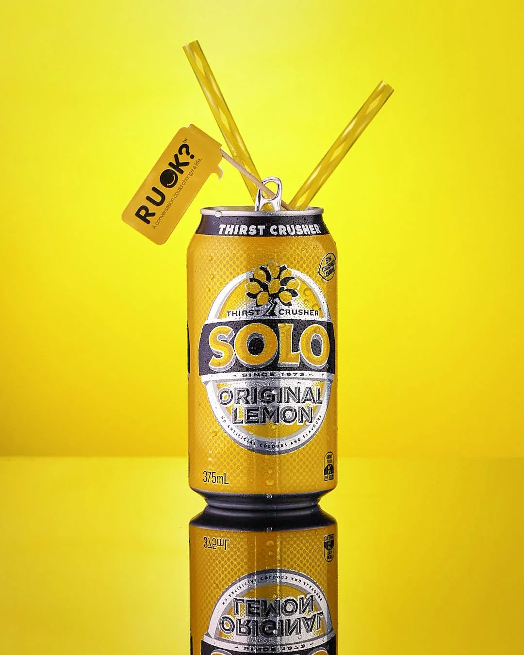 Solo can with two straws and RUOK? Flag Yello and Black captured by Jan - The Resilient Creative - Food Photographer in Far North Queensland Australia