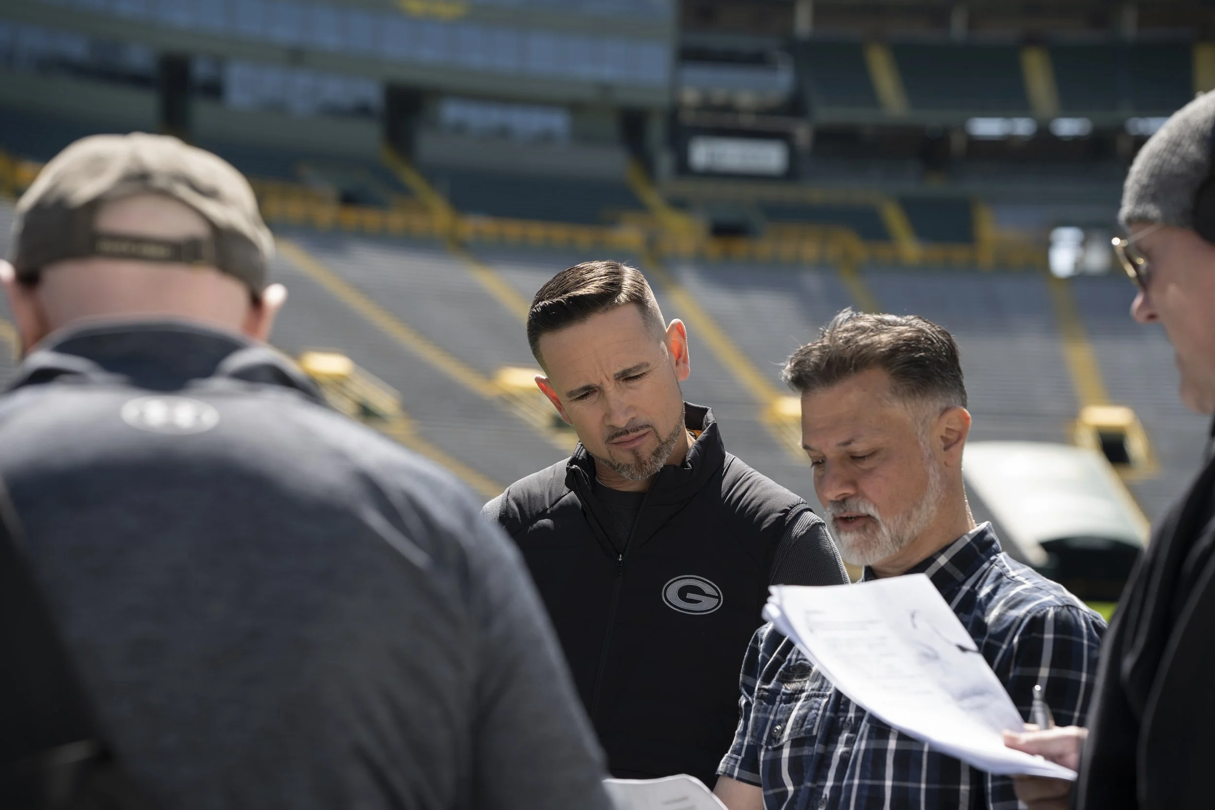 A video production crew going over a script with their talent. 