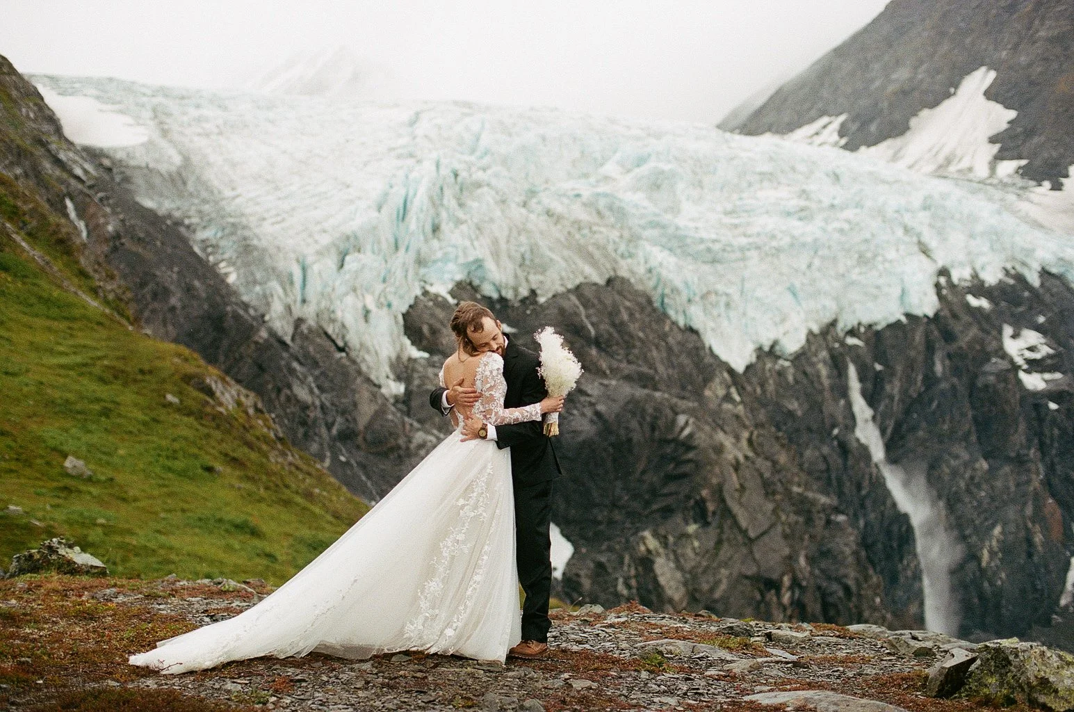 bride and groom hugging alaska