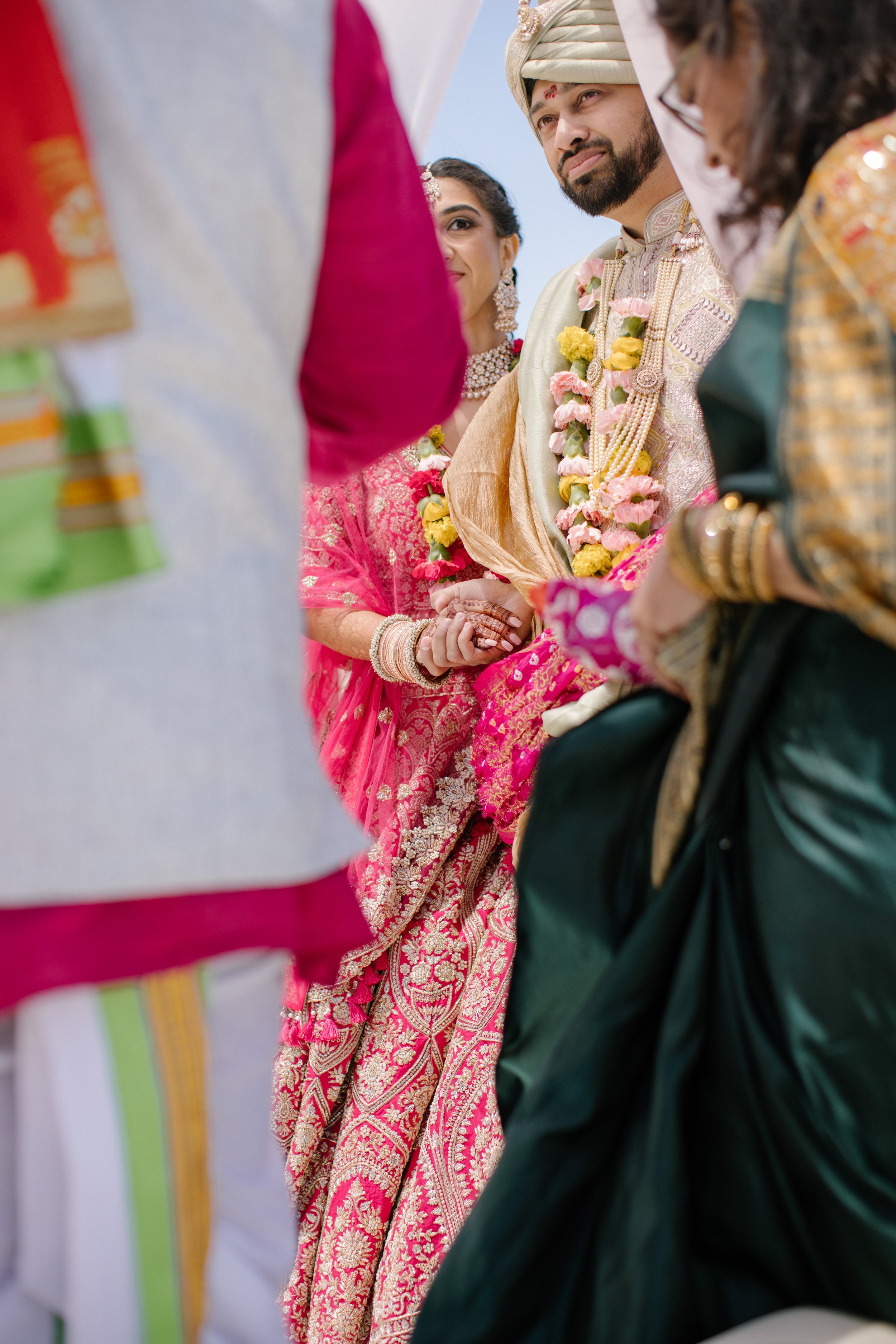 couple holding hands during indian ceremony