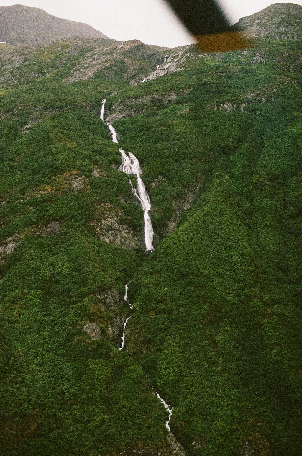 Water falling down mountain in alaska