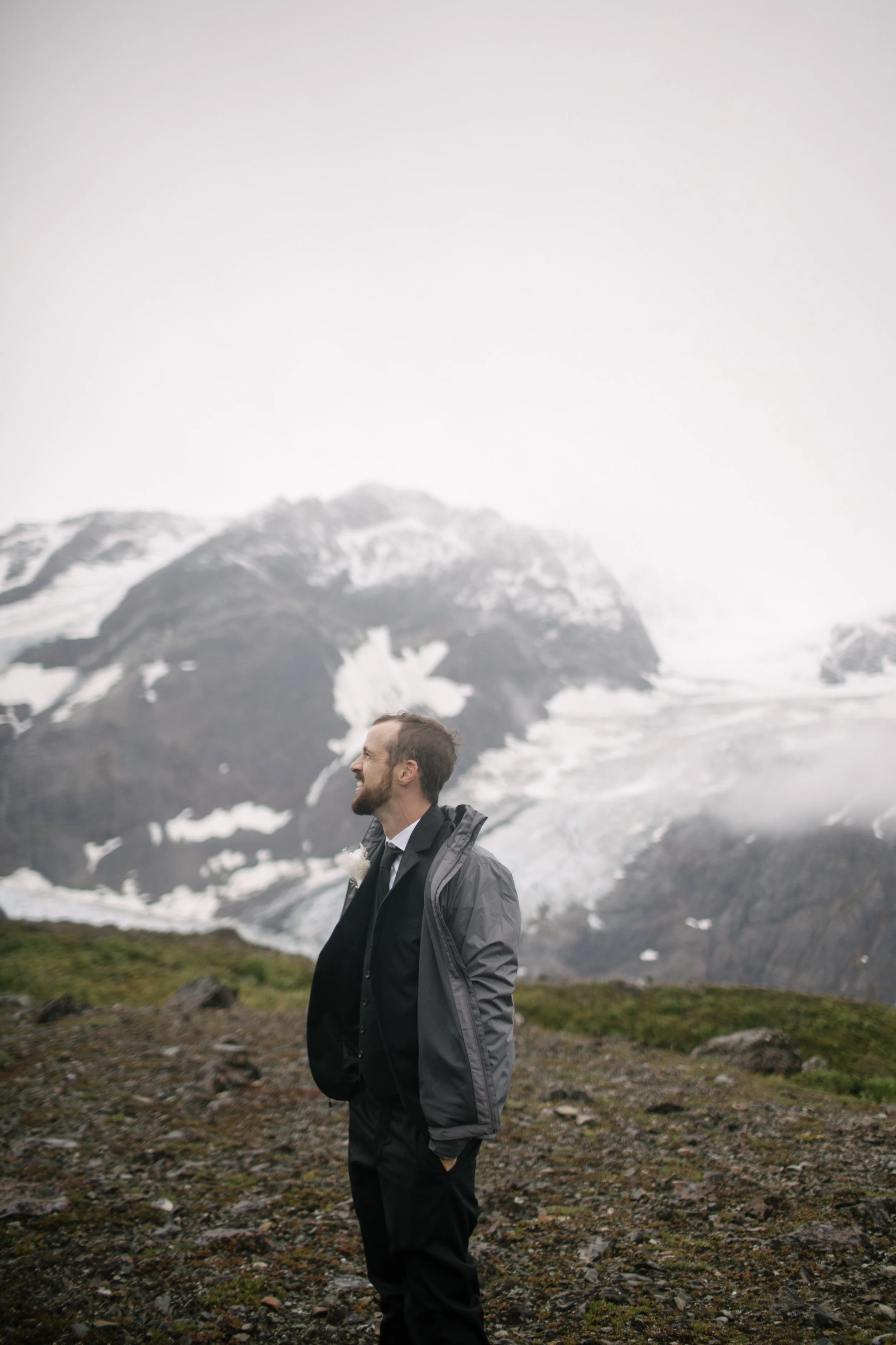 groom looking at glacier